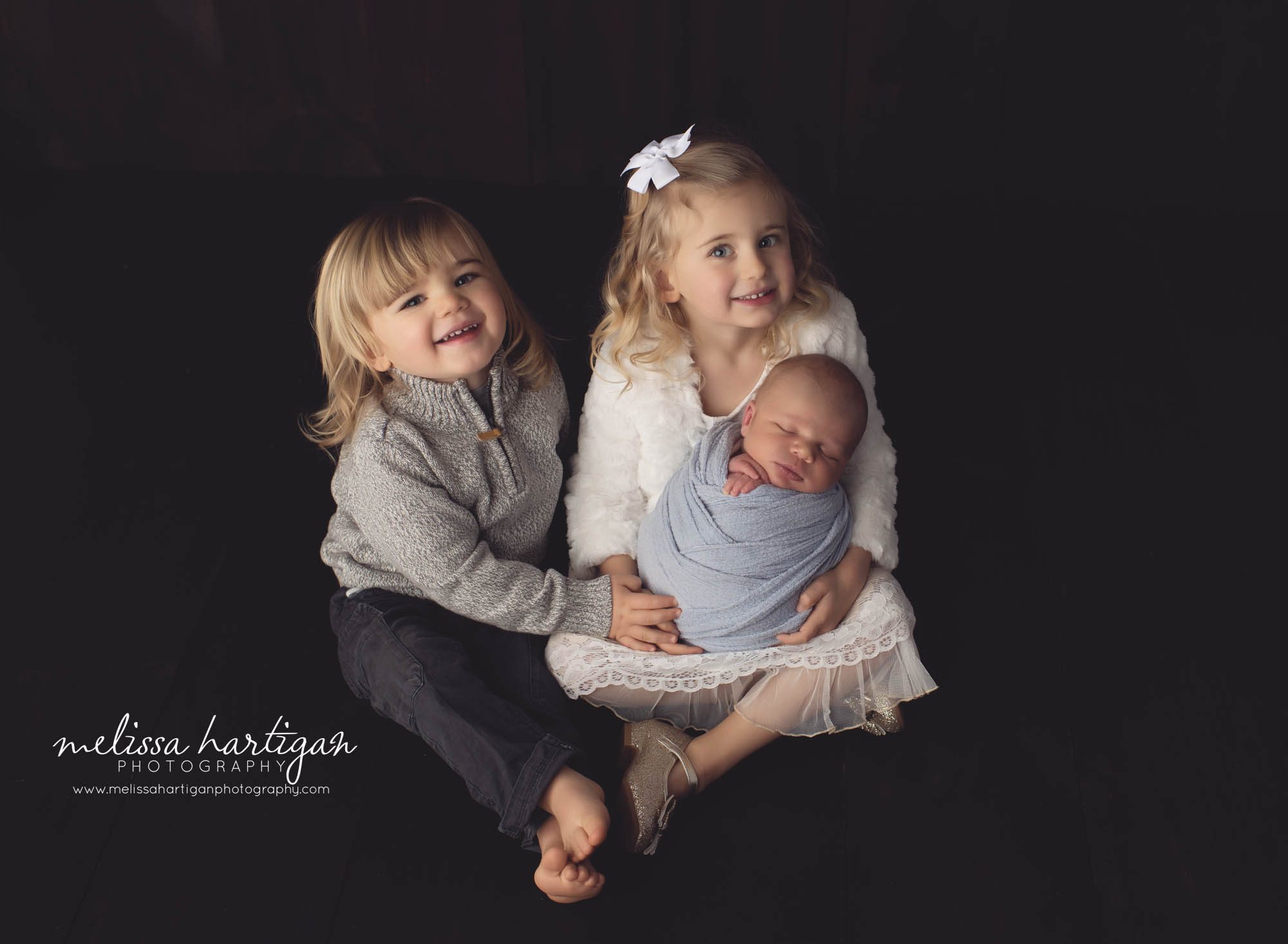 big sister big brother posed with newborn baby brother studio family photo CT baby photographer