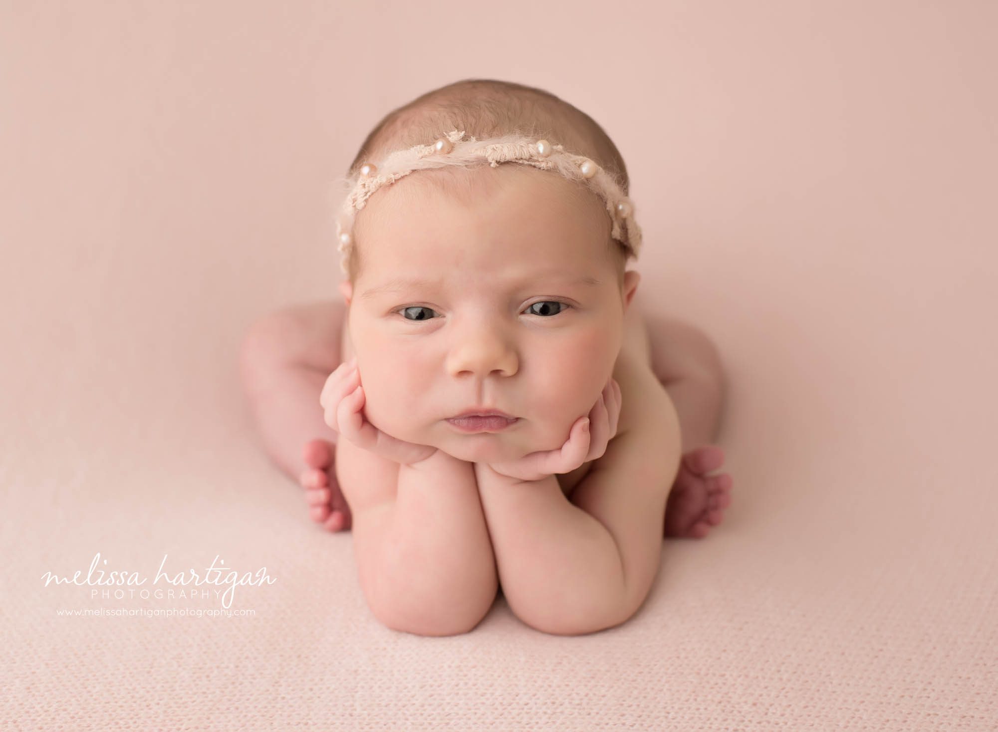 Newborn baby girl posed in froggy pose newborn photography