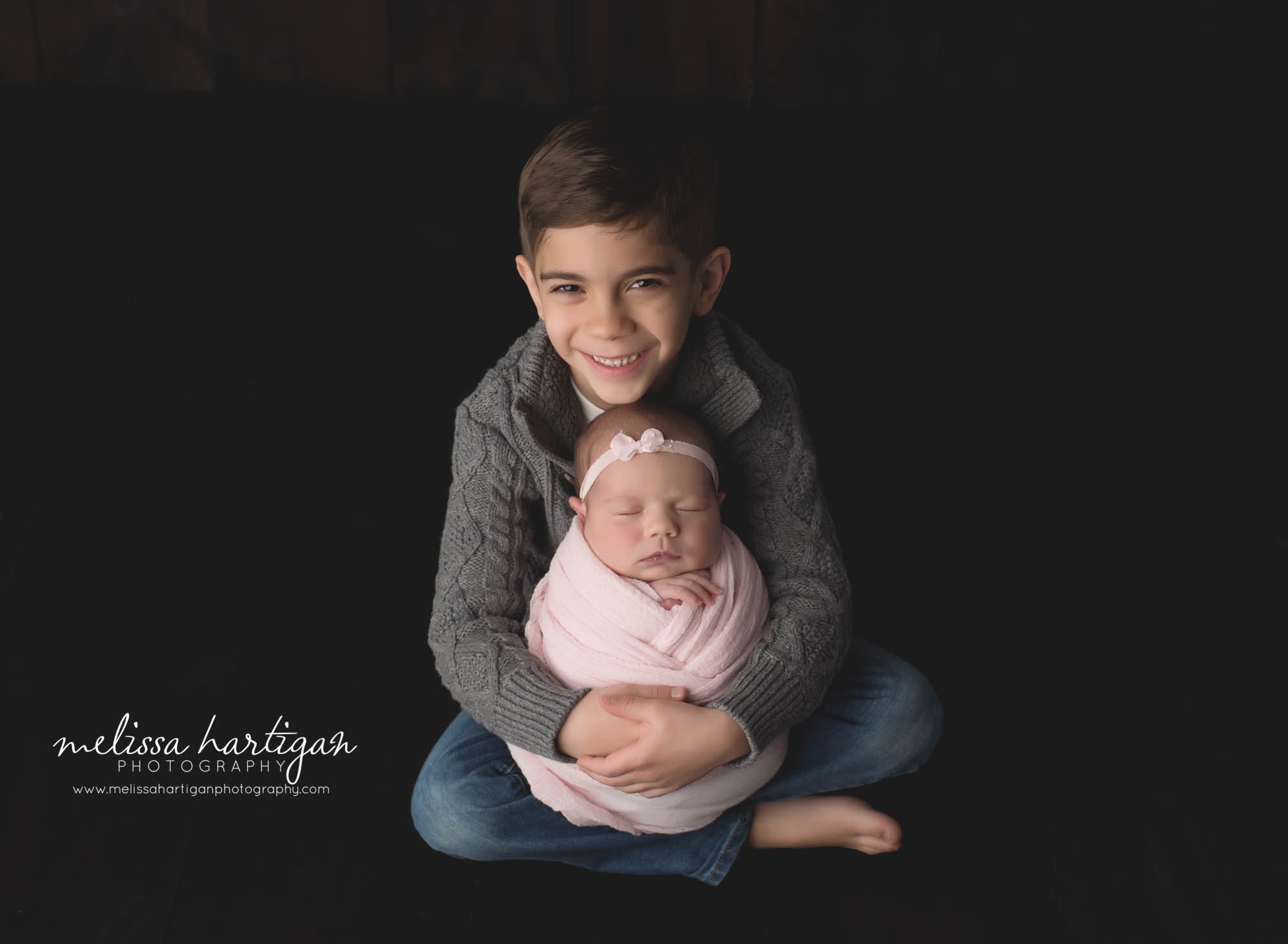 big brother holding newborn baby sister studio photography session Coventry Newborn photographer