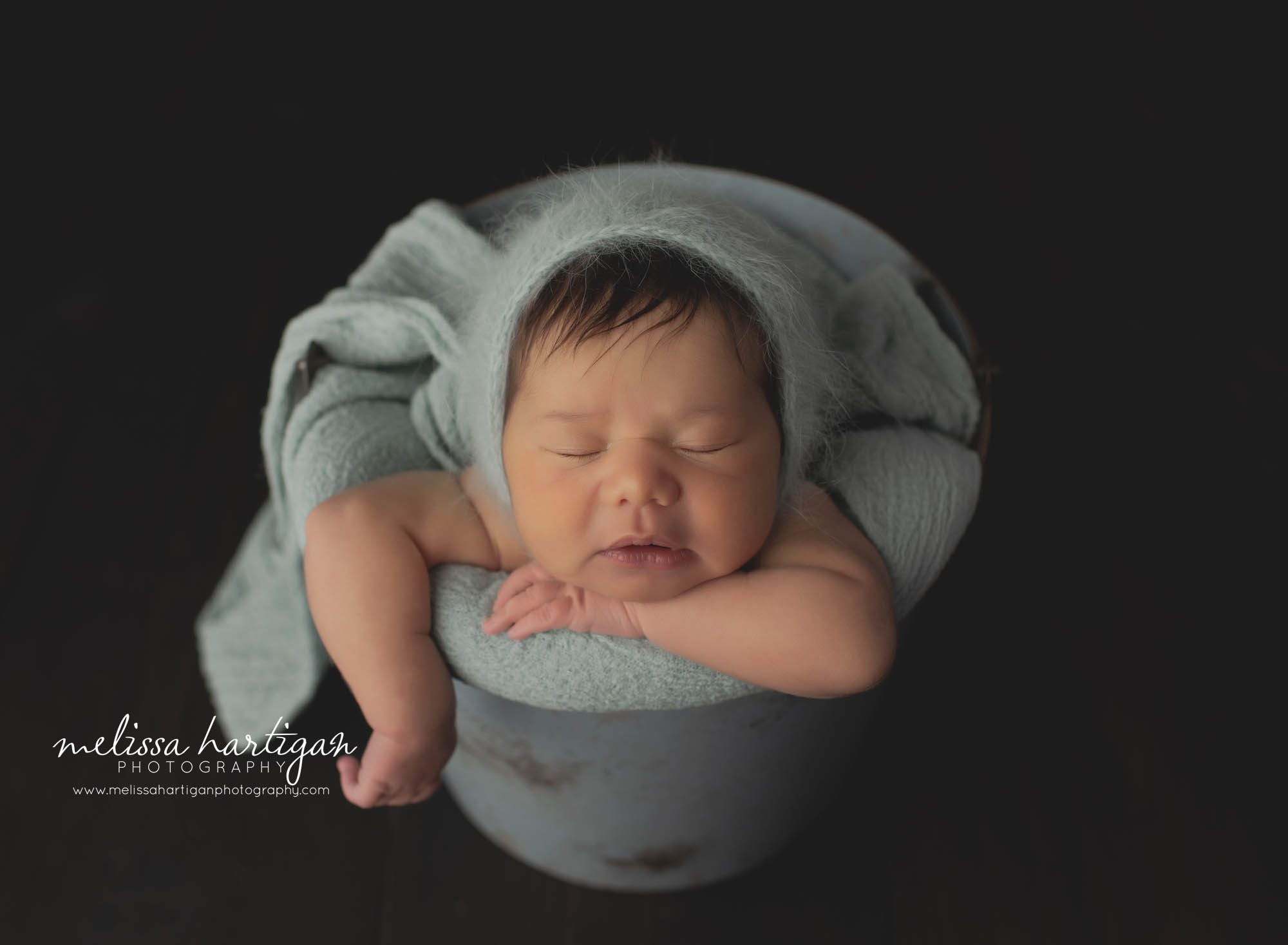 newborn baby girl posed in metal bucket with sea green wrap and knitted bonnet CT newborn Photography