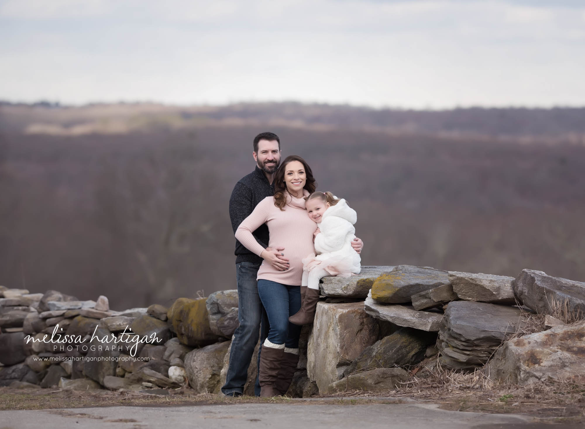 mom dad and big sister-to-be family maternity photo outside connecticut