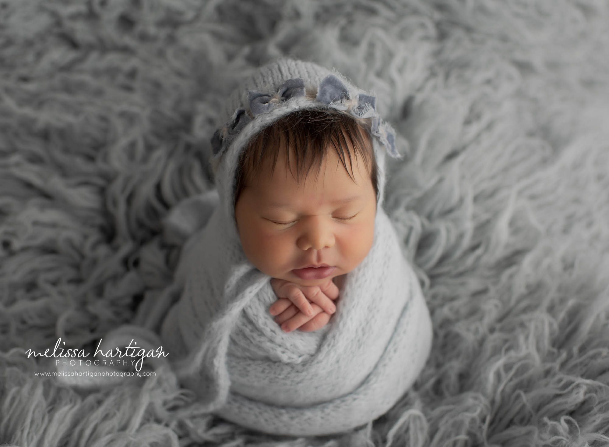 newborn baby girl wraped in grey wrap and bonnet connecticut newborn photographer