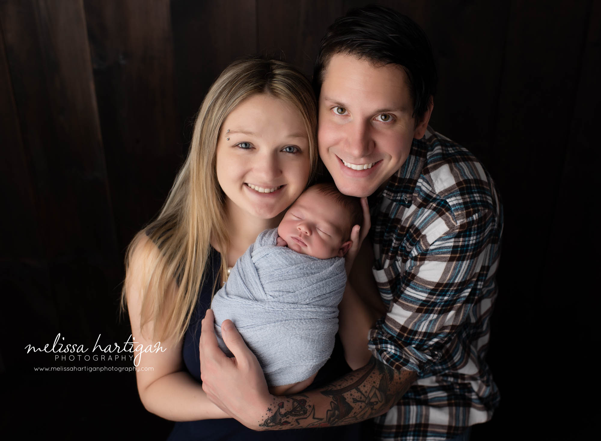 Mom dad and newborn baby boy wrapped in blue wrap family photo Newborn photography session