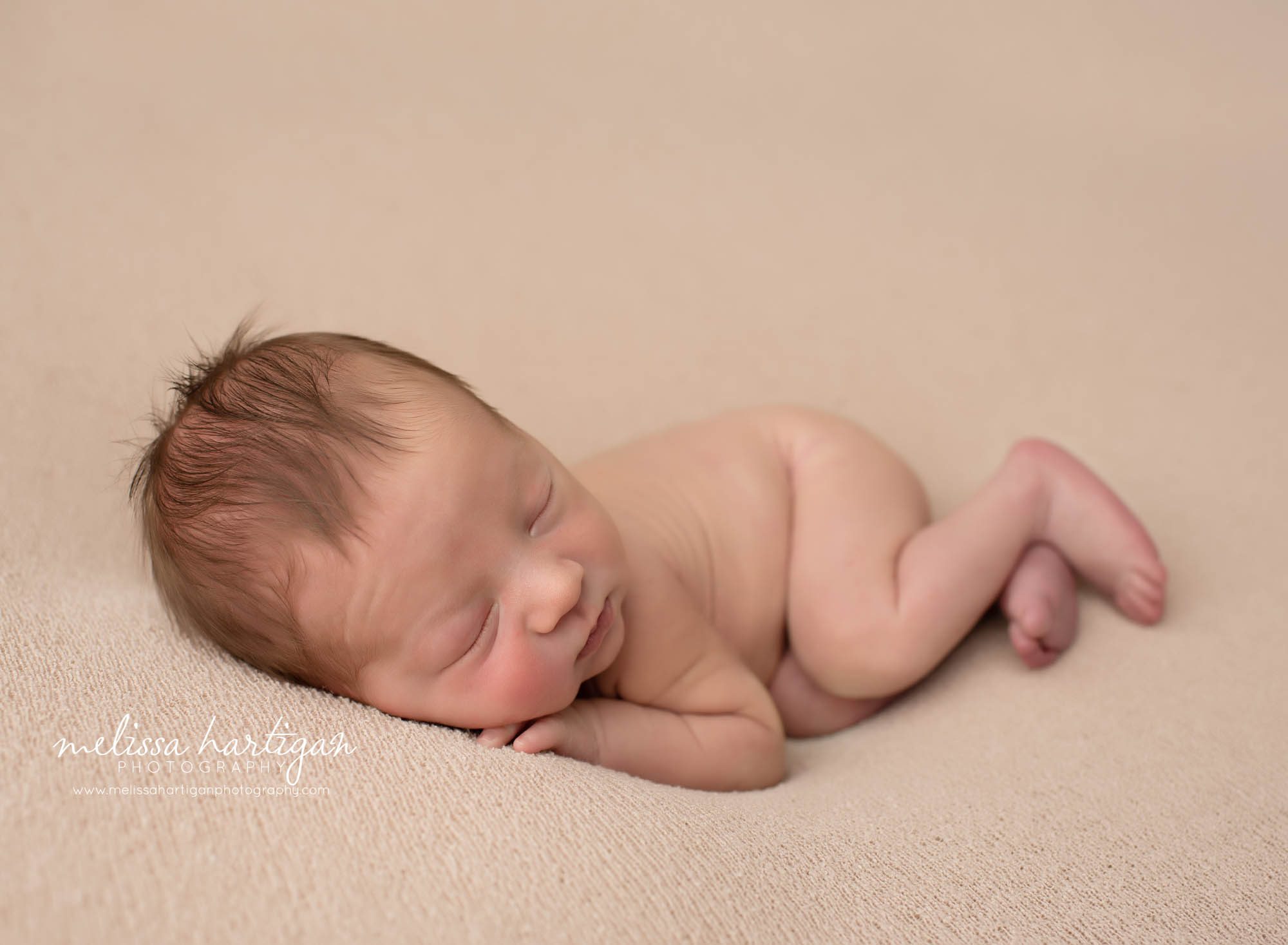 Newborn baby boy posed on side tummy on backdrop Newborn Photographer CT