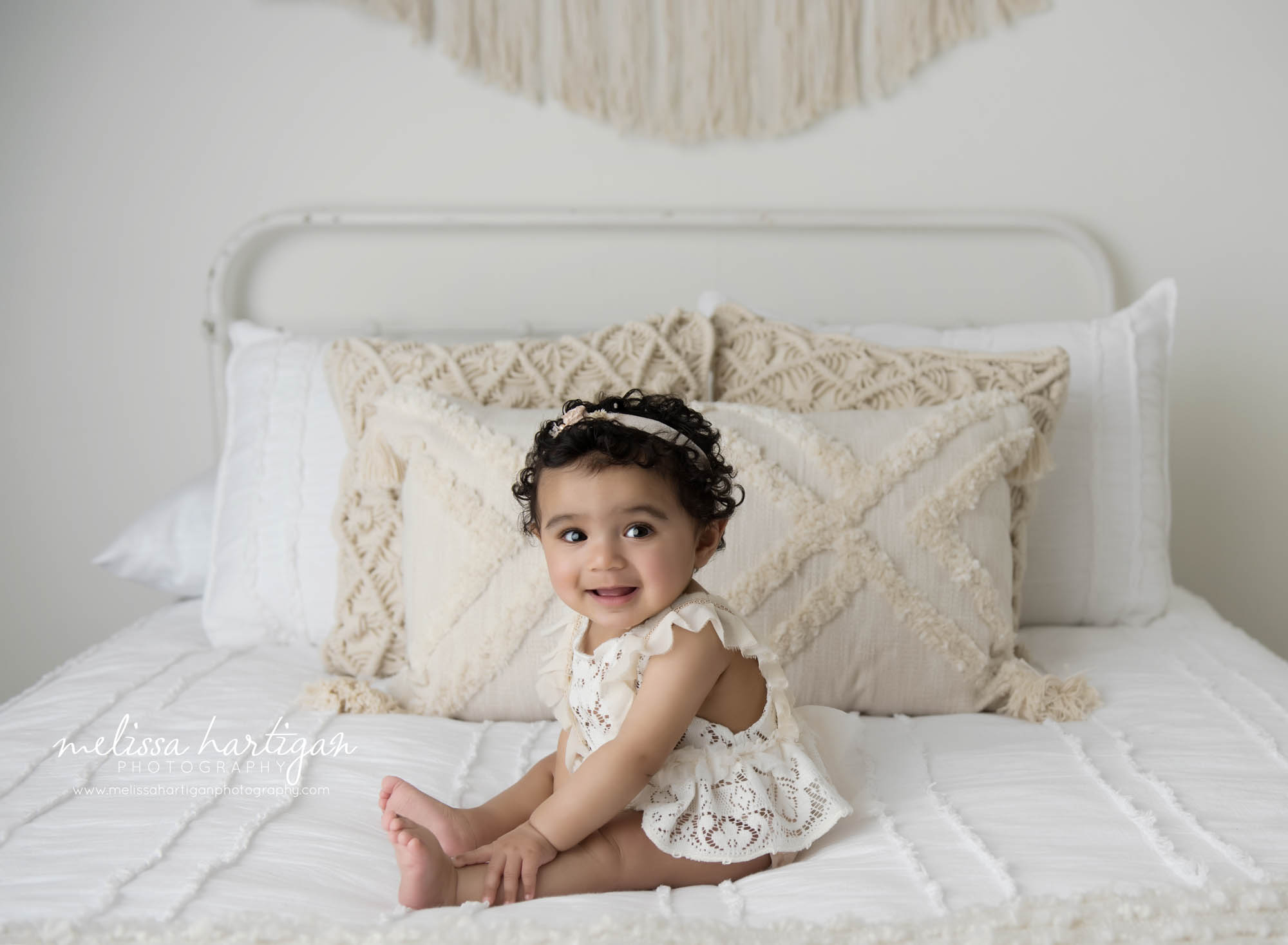Baby girl sitting on bed in baby milestone session Colchester CT baby photography