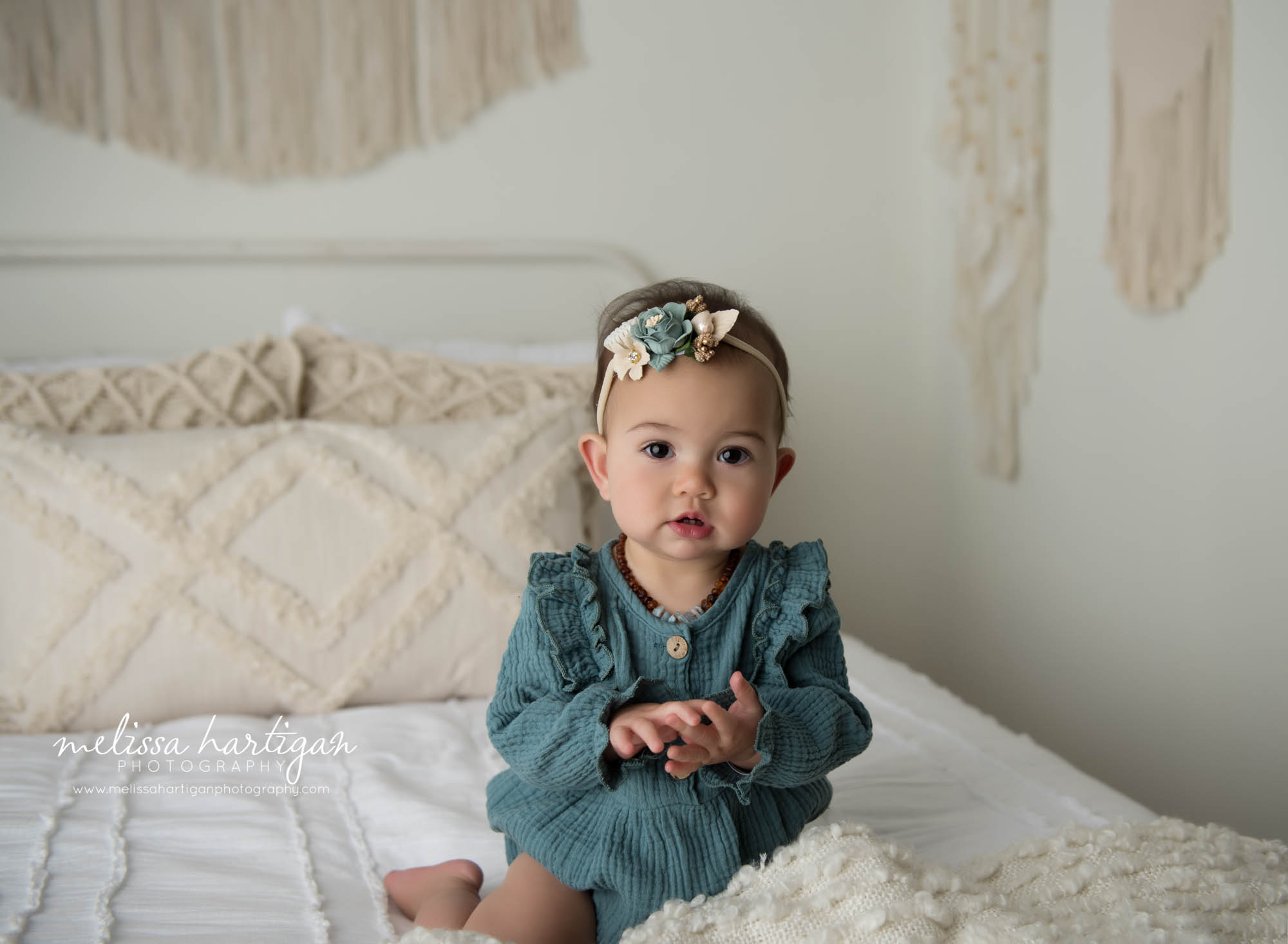 baby girl sitting on bed in studio milestone session CT Baby Photography