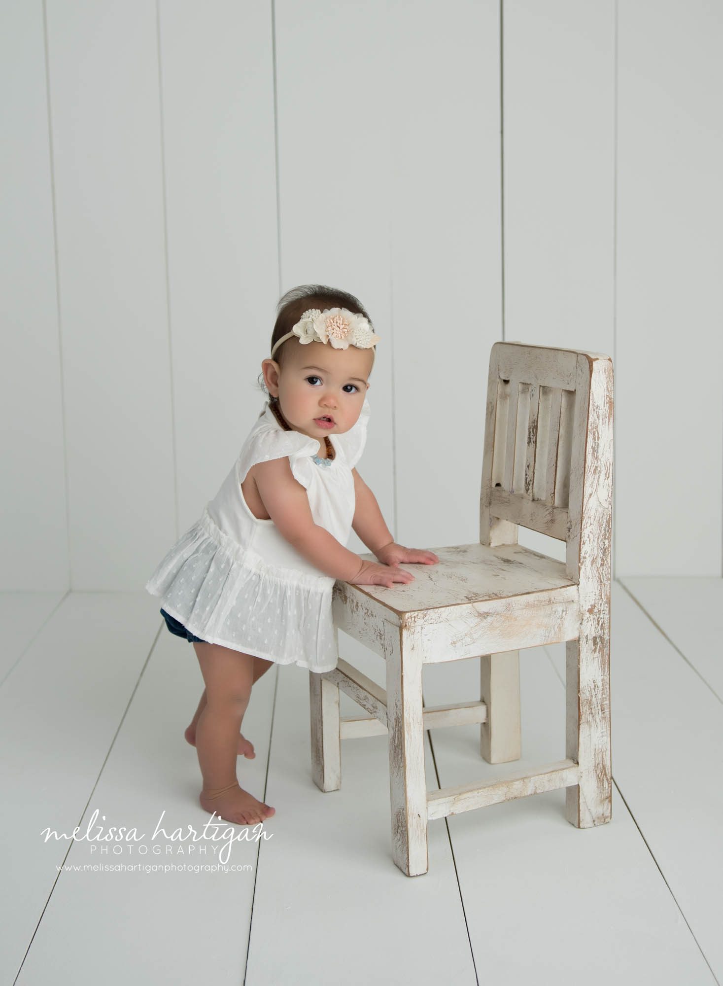 baby girl standing with hands on chair baby milestone photography CT