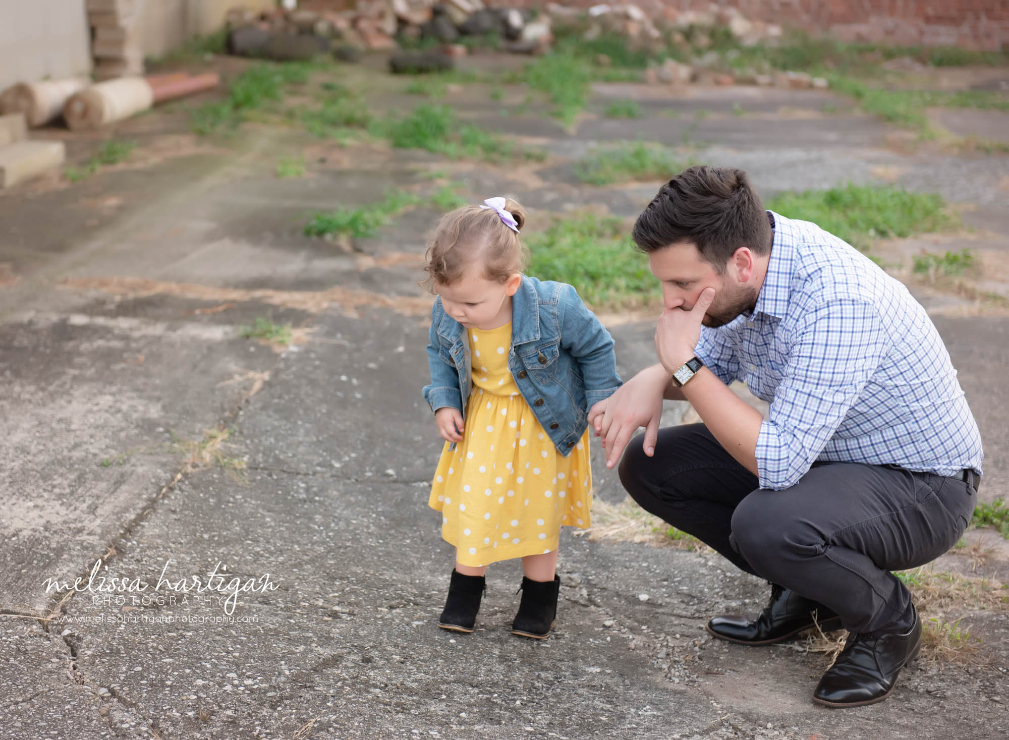 daughter and dad looking at something on the ground