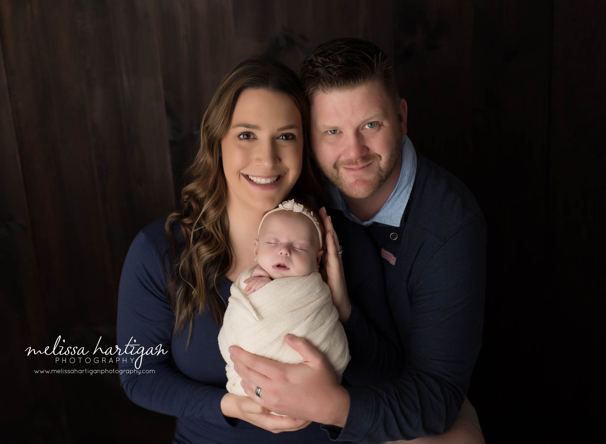 mom dad and newborn baby girl wrapped in cream wrap family photo newborn photographer CT