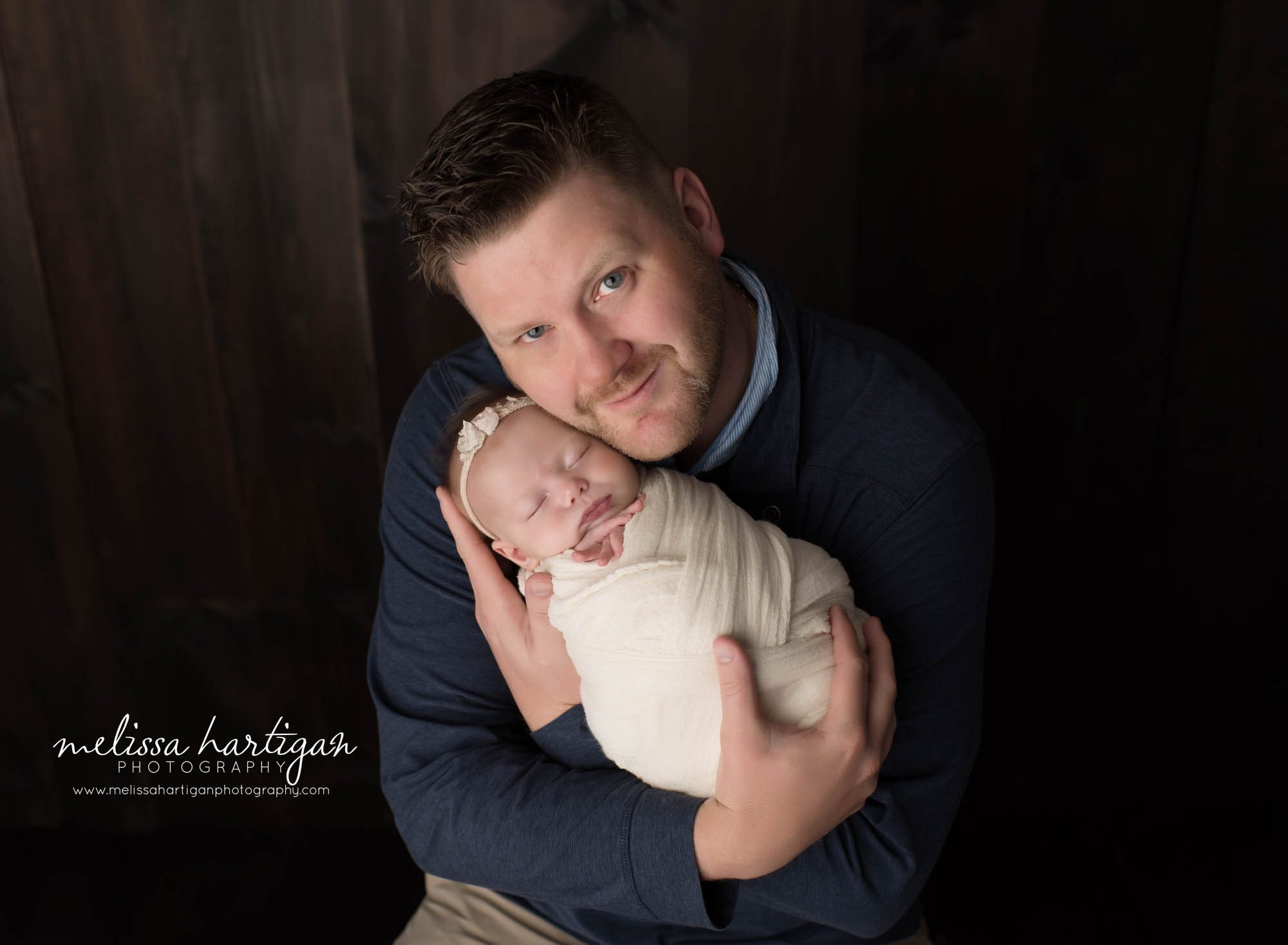 Dad holding wrapped newborn daughter in family pose CT newborn photographer