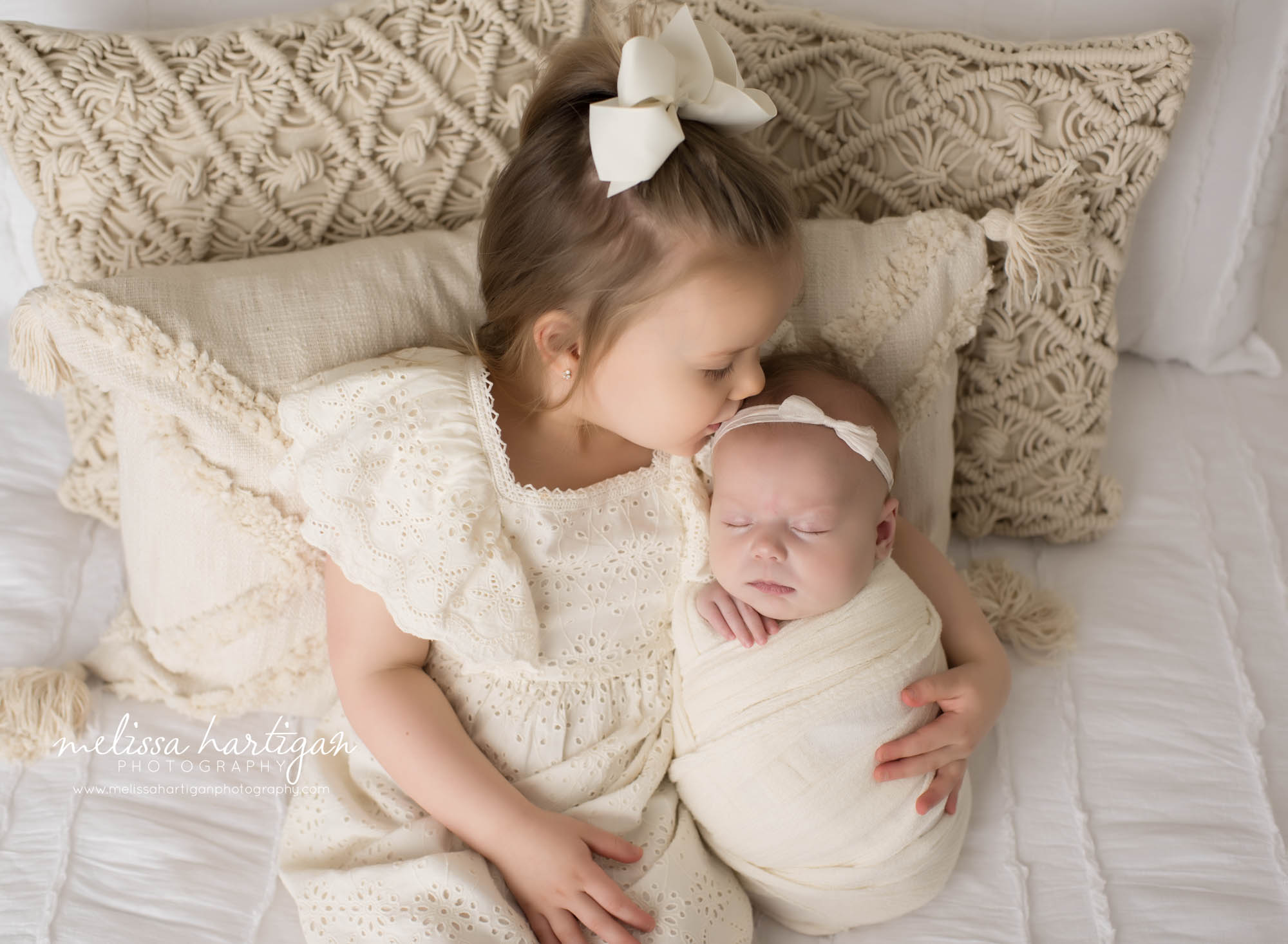 big sister kissing baby sister on head family photo newborn photographer CT