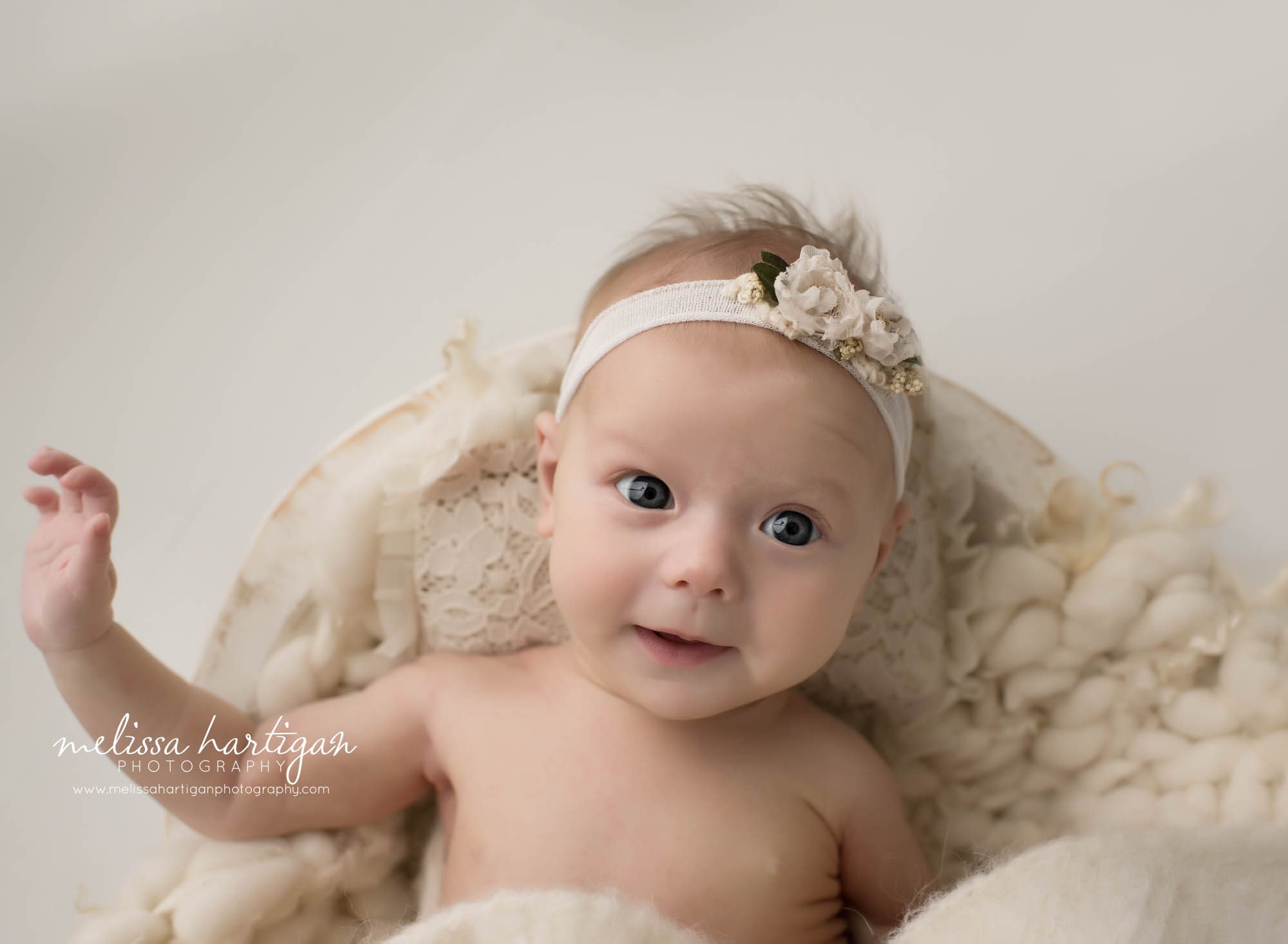awake newborn baby girl picture with cream layer wrap Best CT newborn photographer Best CT newborn photography
