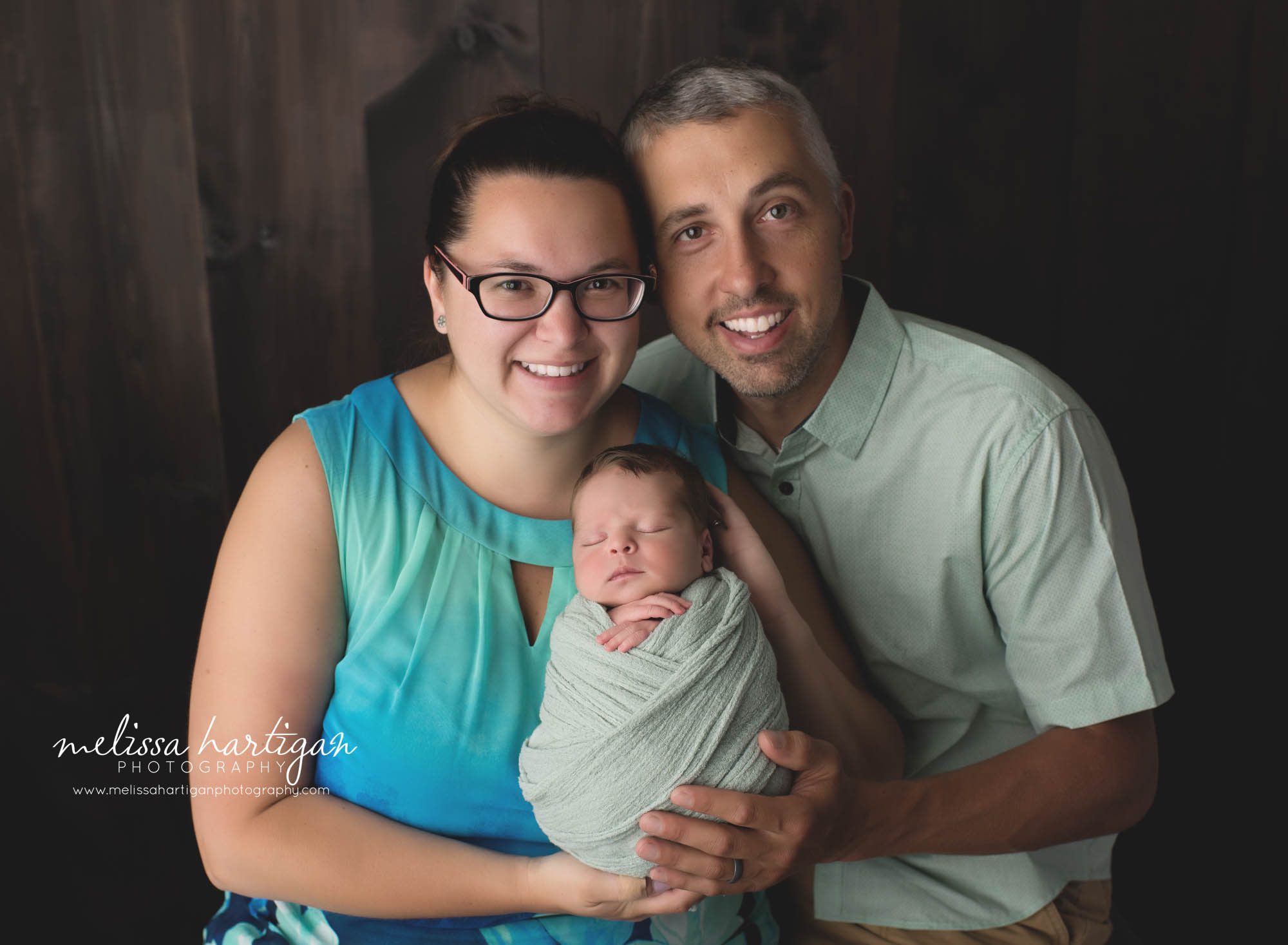 mom dad and newborn baby boy family picture