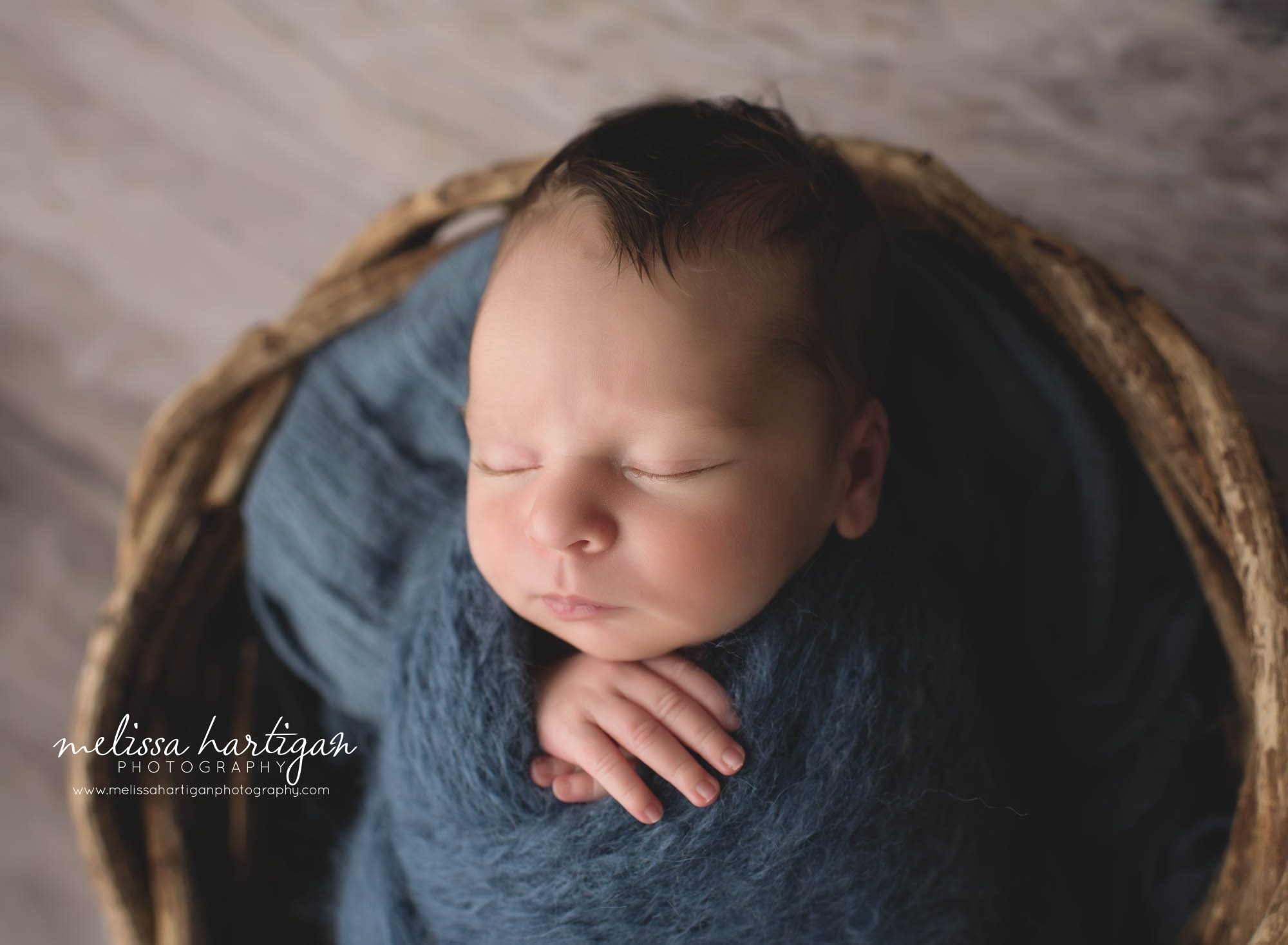 newborn abby boy wrapped in blue posed in basket