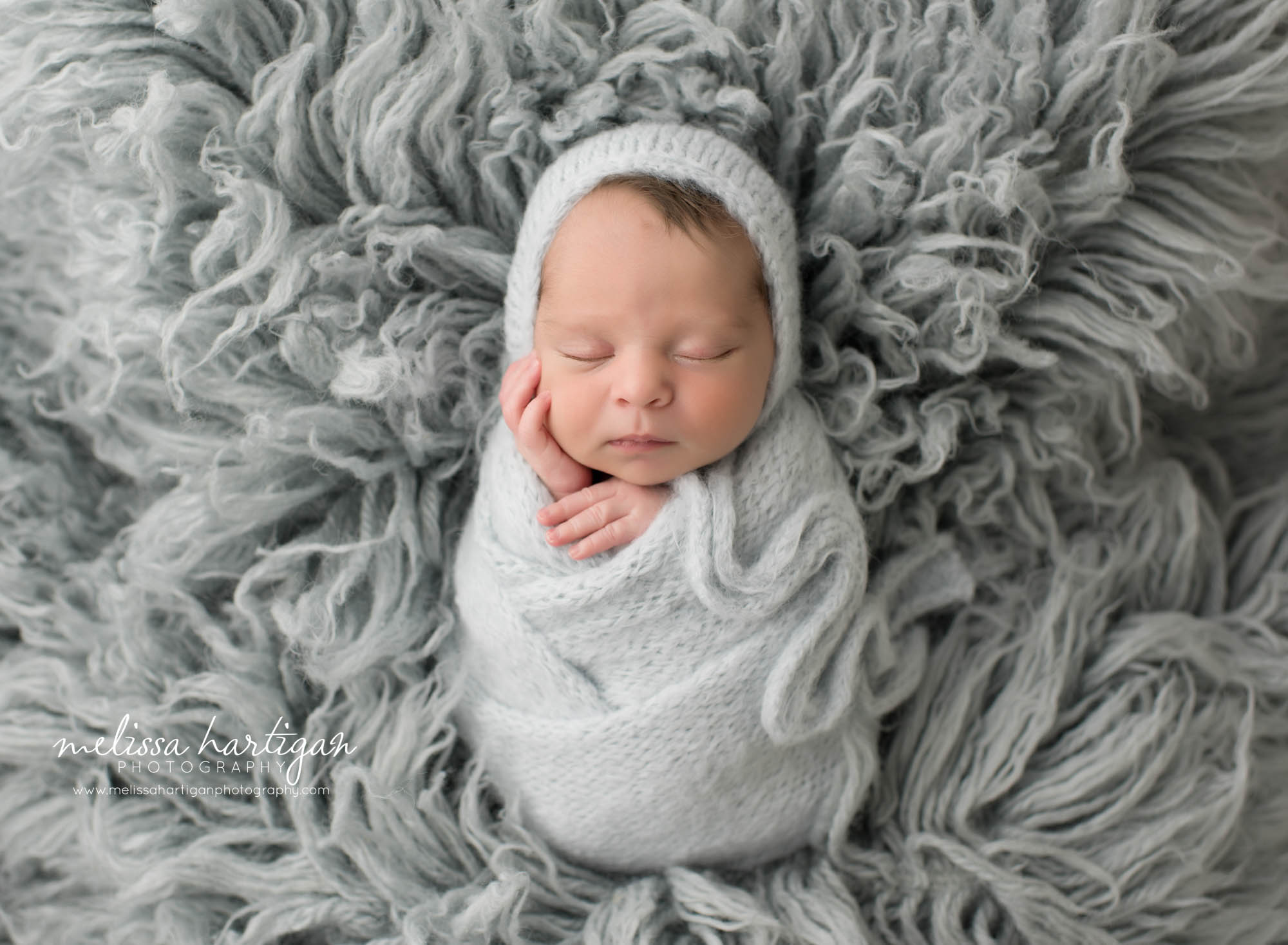 newborn baby boy wraped in gray wrap with knitted bonnet Newborn Photography East Hartford CT