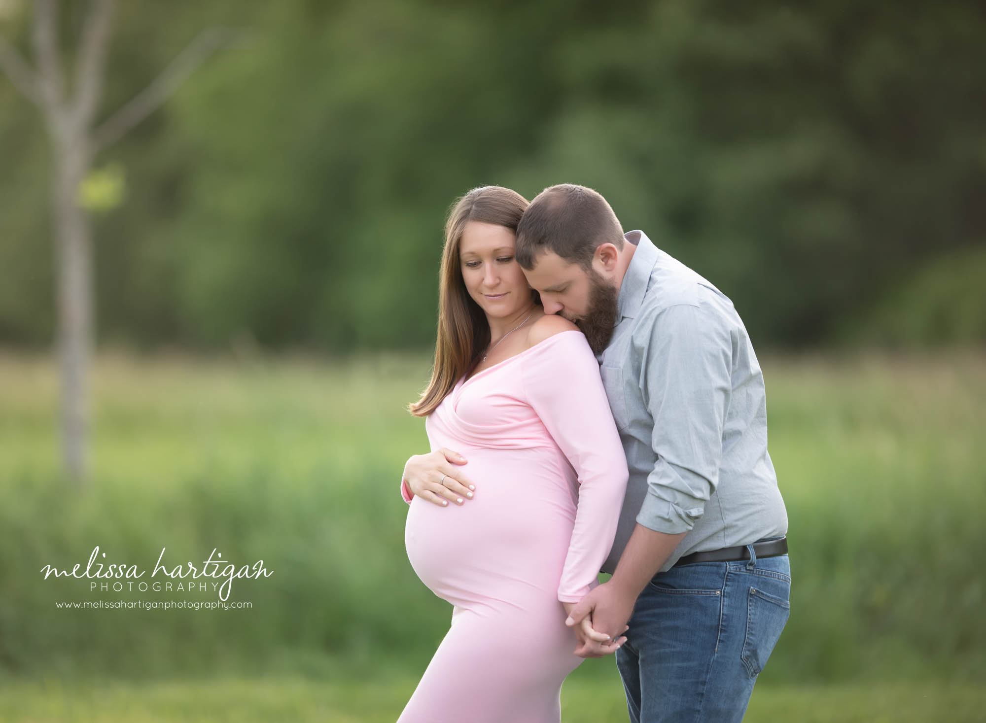 dad kissing pregnant wife on shoulder Connecticut maternity photographer CT maternity newborn photography