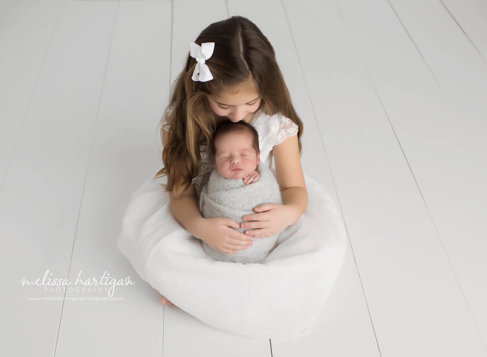 big sister holding new baby brother Hartford country newborn sibling photography