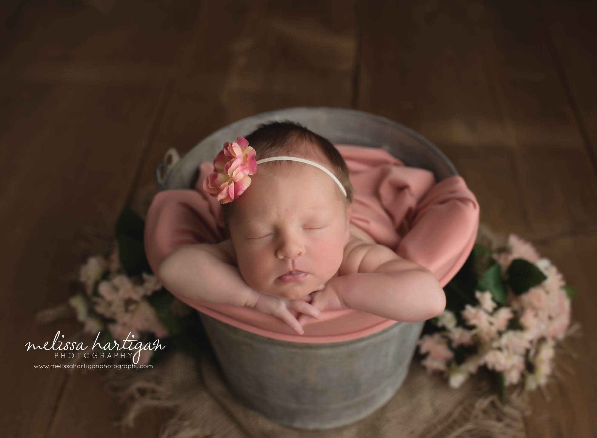 Nerwborn baby girl posed in metal tub with head on hands pose newborn photography CT