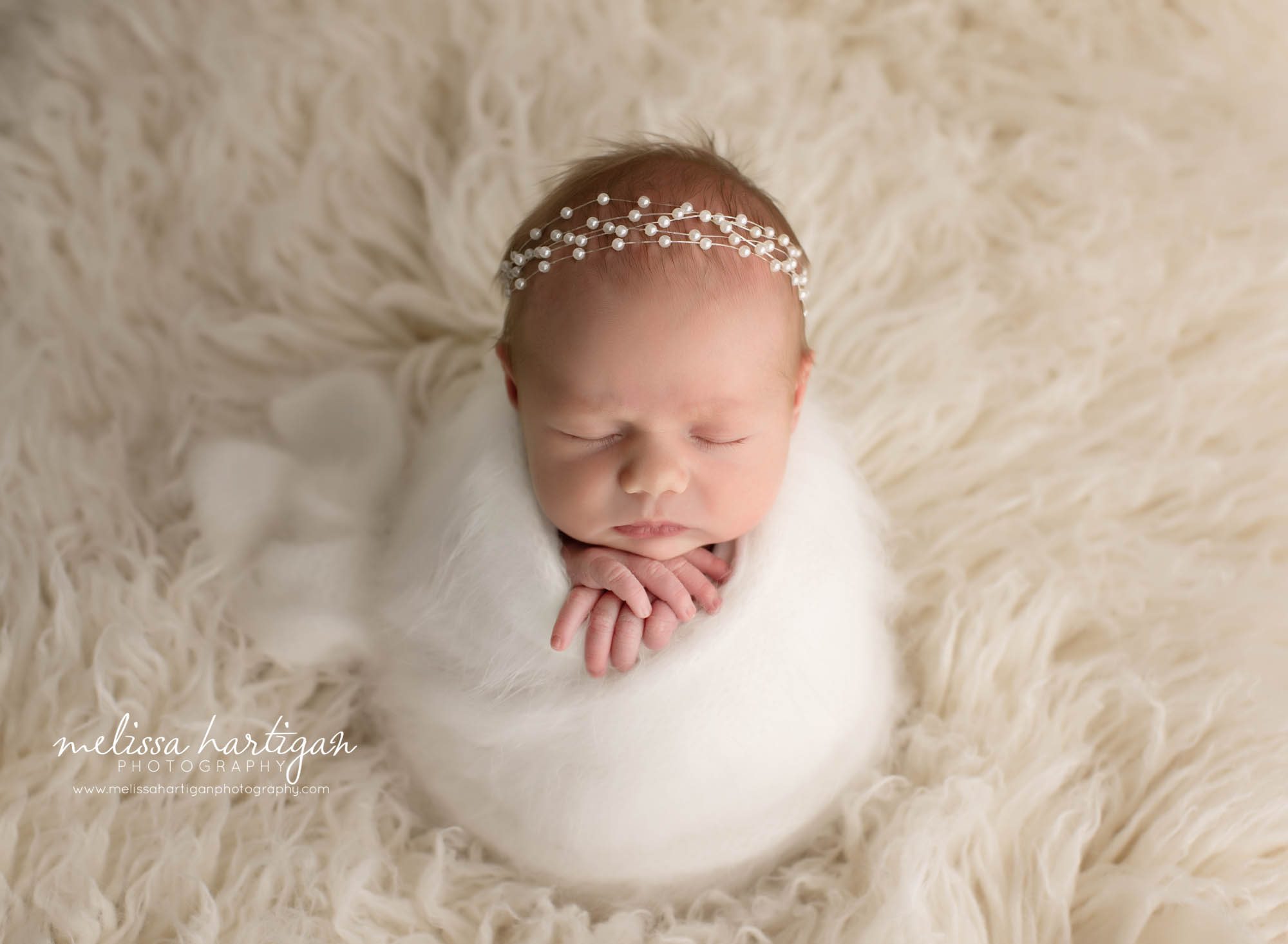Newborn Baby girl wrapped in white wrap with white pearl bead headband CT newborn Photographer