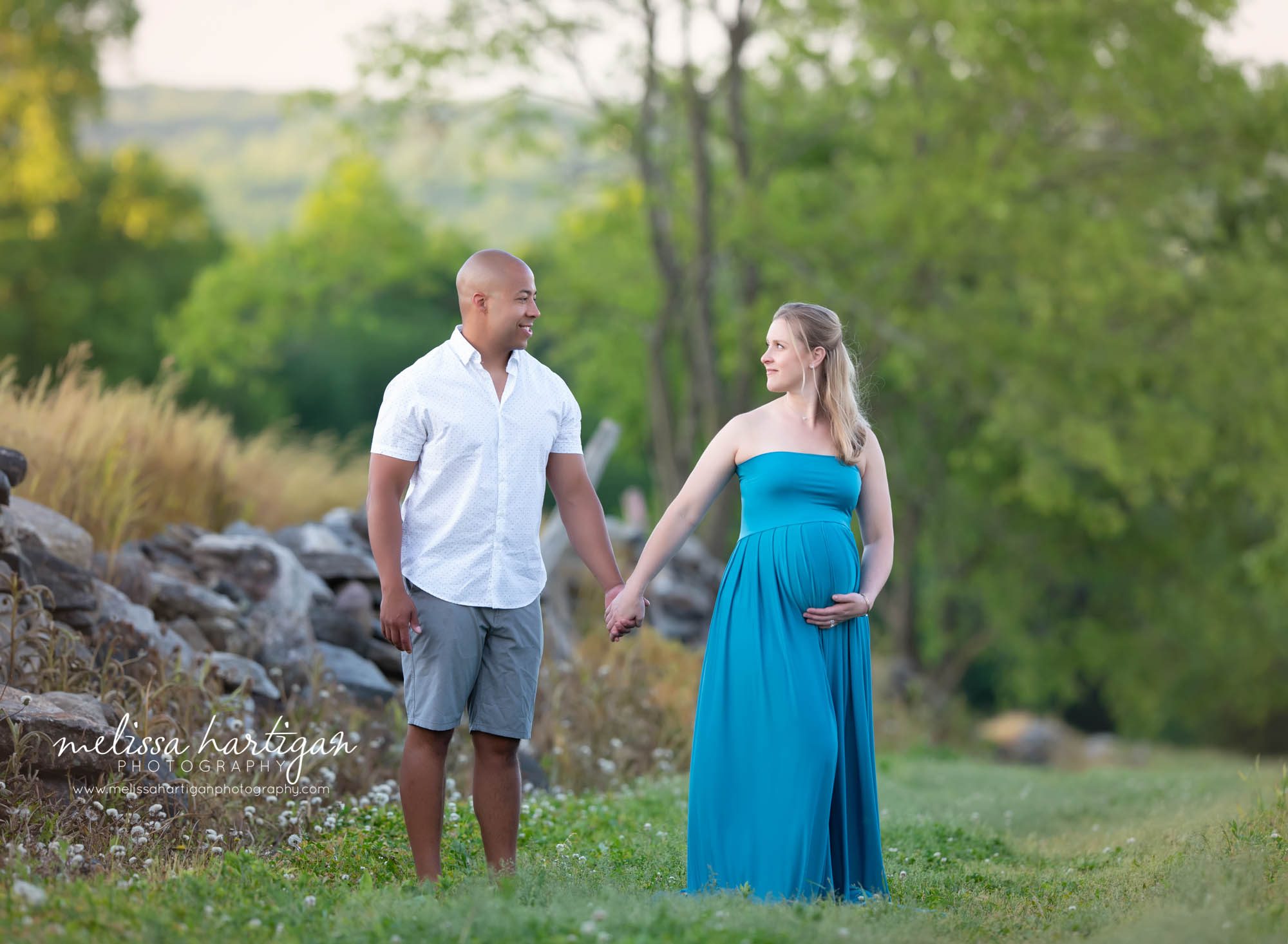 mom and dad to be walking holding hands waiting for baby pregnancy picture CT maternity Photography
