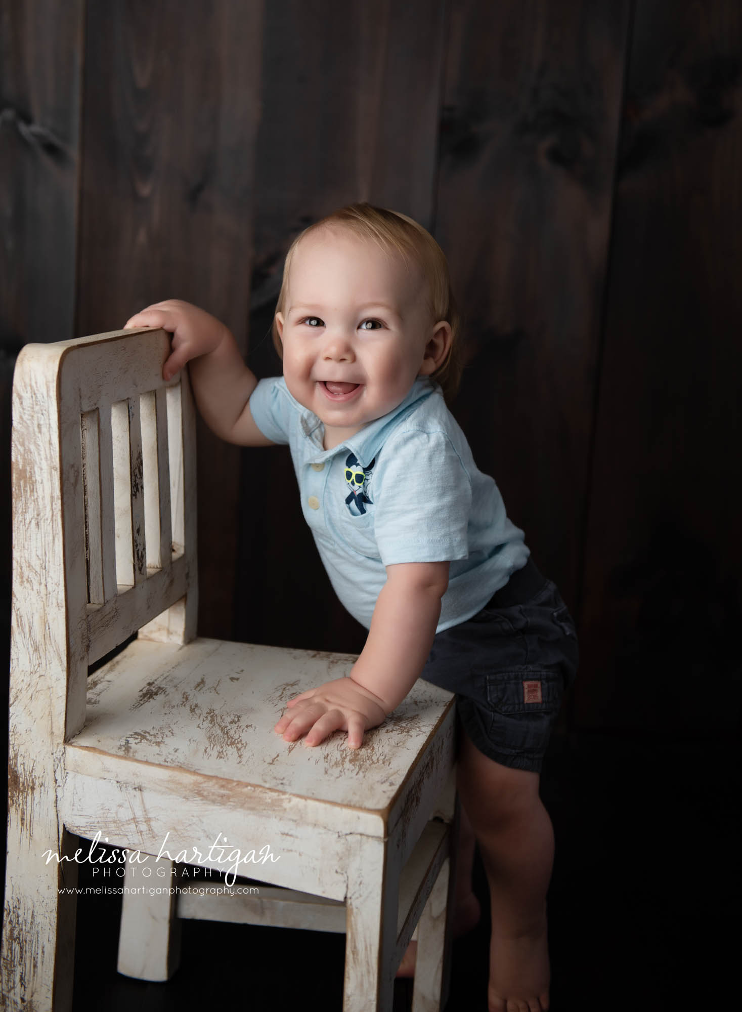 baby boy standing up beside chair baby photography columbia ct