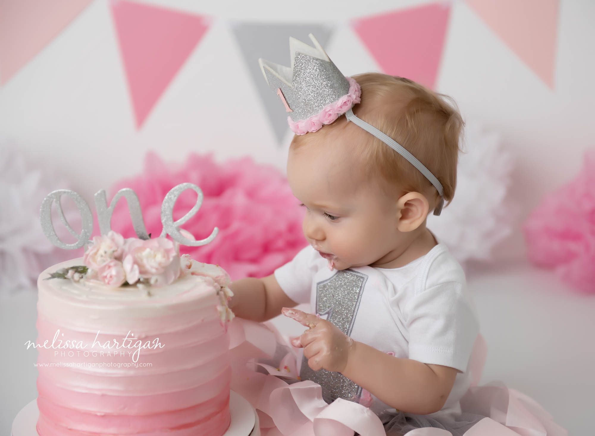 baby girl getting into cake from cake smash photography session