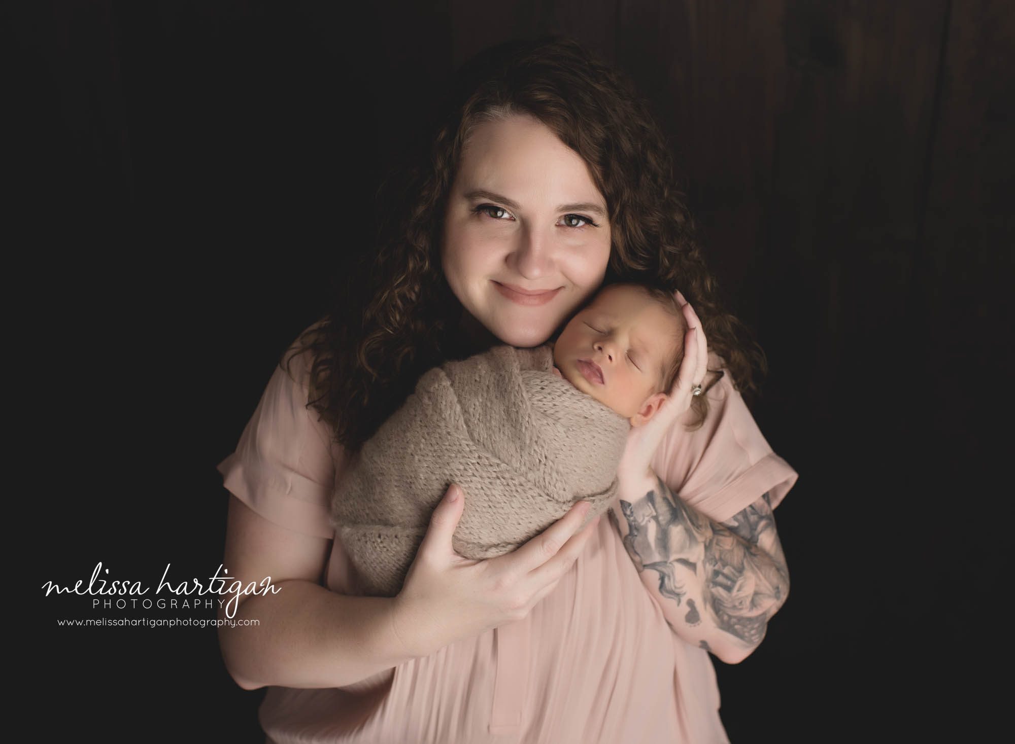 mom holding newborn son in parent photo newborn photography session CT newborn Photographer