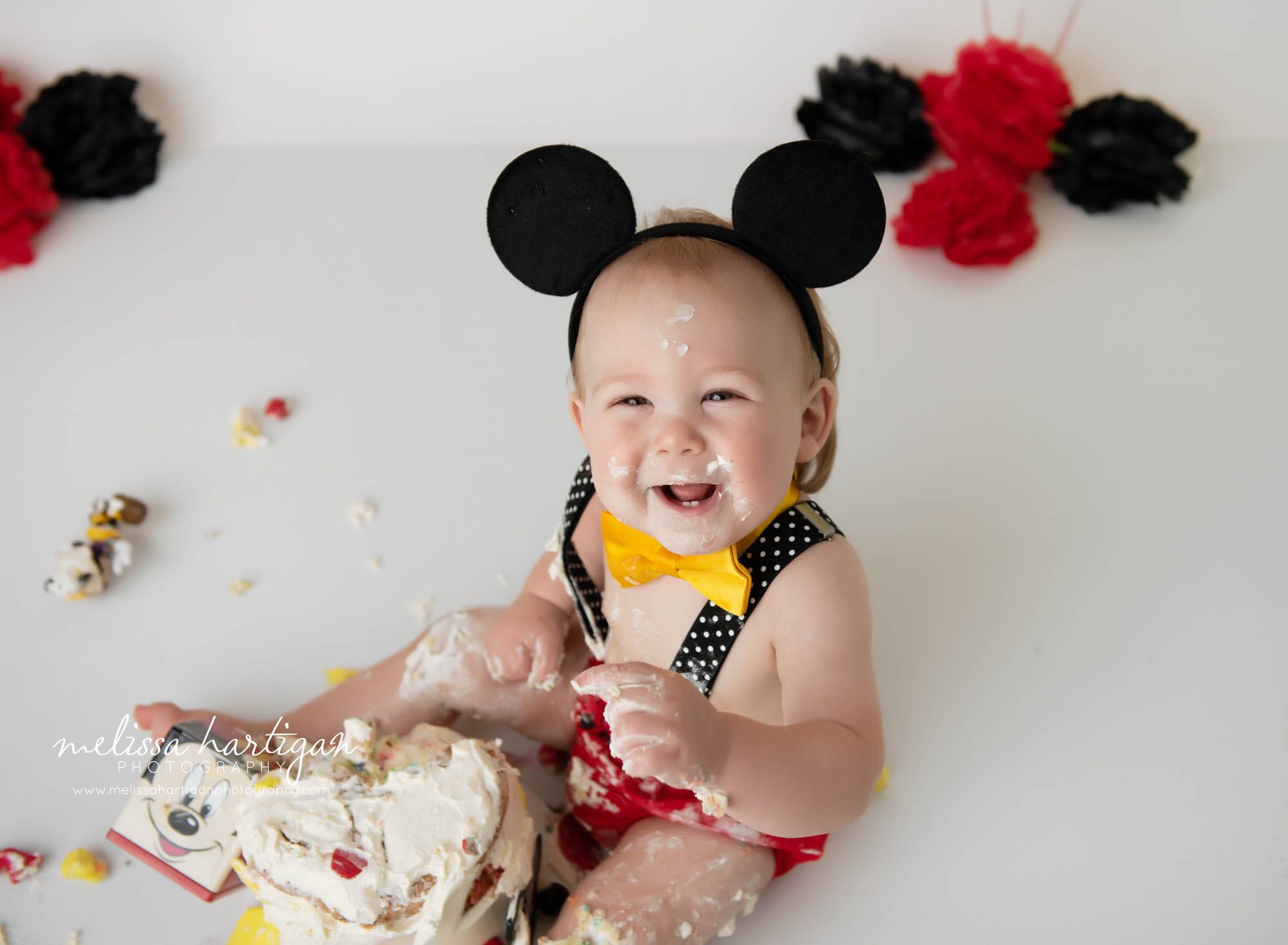 baby boy smiling laughing making mess with mickey mouse cake smash
