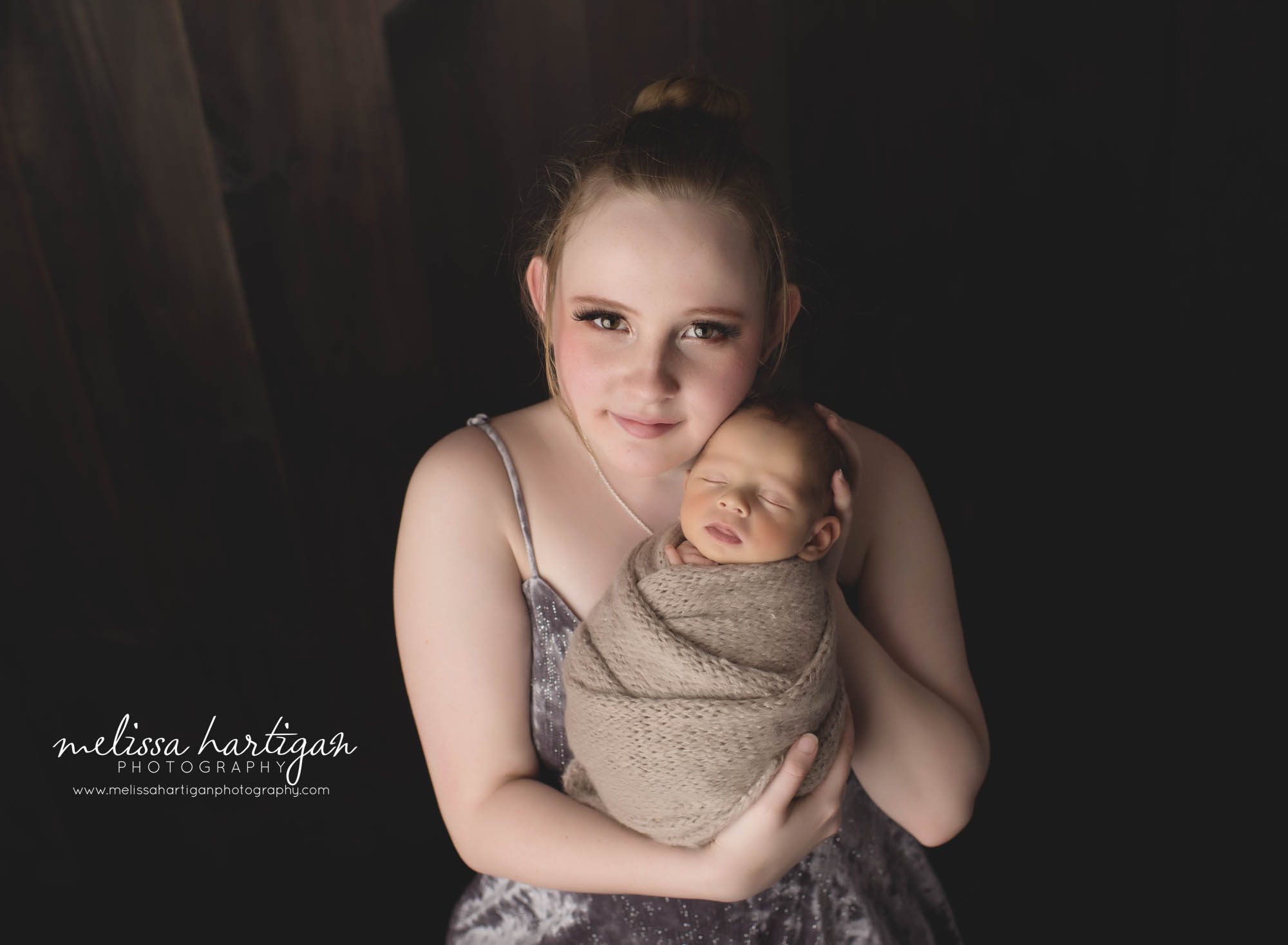 big sister holding newborn baby brother in studio newborn photography session Ct Newborn Photographer