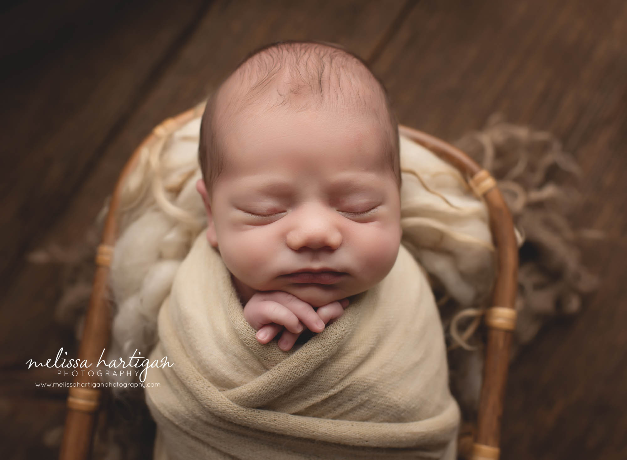 newborn baby boy wrapped and posed in basket with fluffy layer Stratford CT newborn photographer