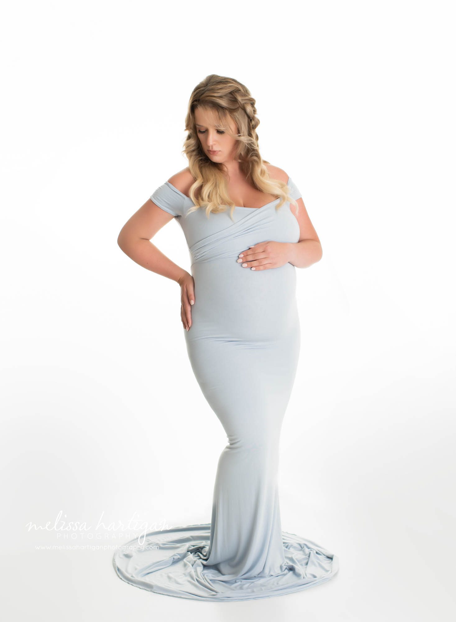 Pregnant mom holding belly wearing long form fitting light blue maternity gown enfield CT maternity Photography