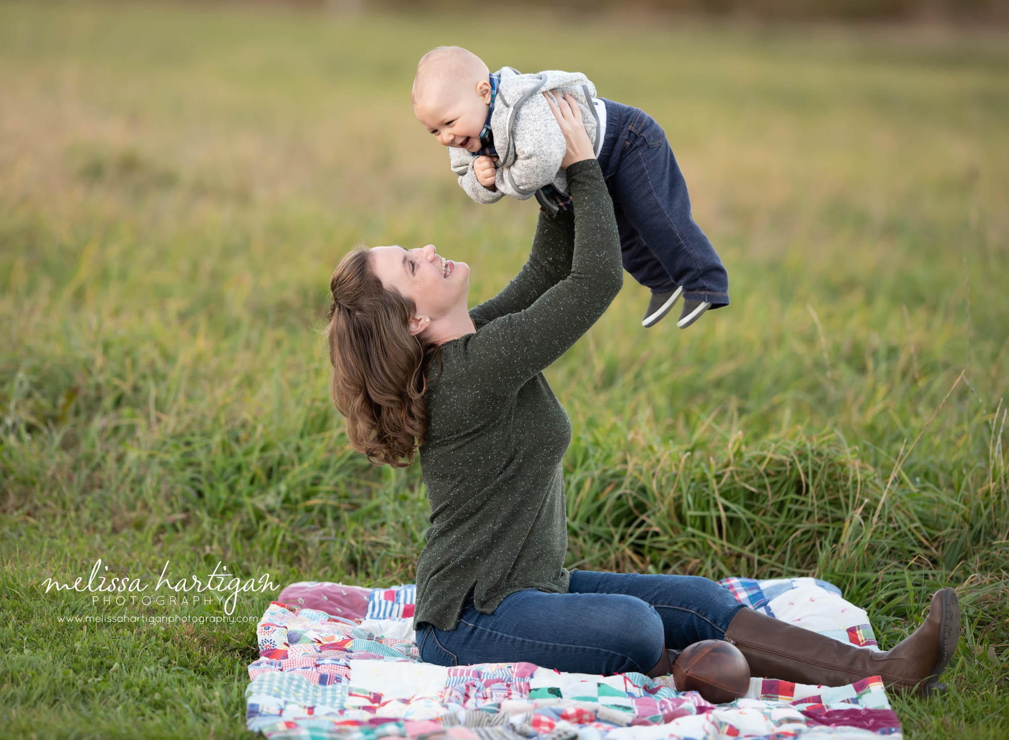 mom holding up her baby boy making him laugh CT family Photography