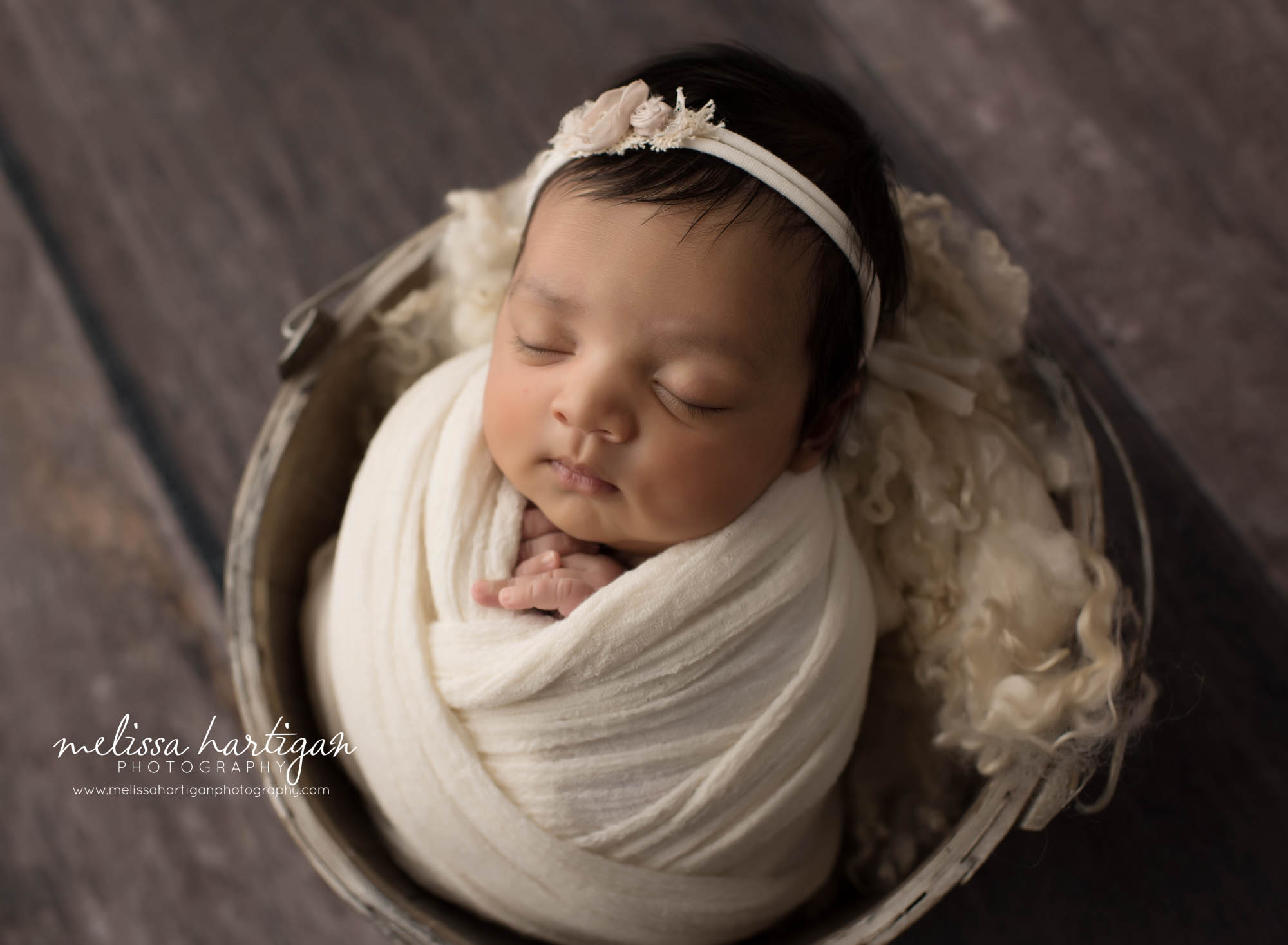 newborn baby girl wrapped in cream wrap with flower headband CT newborn photography