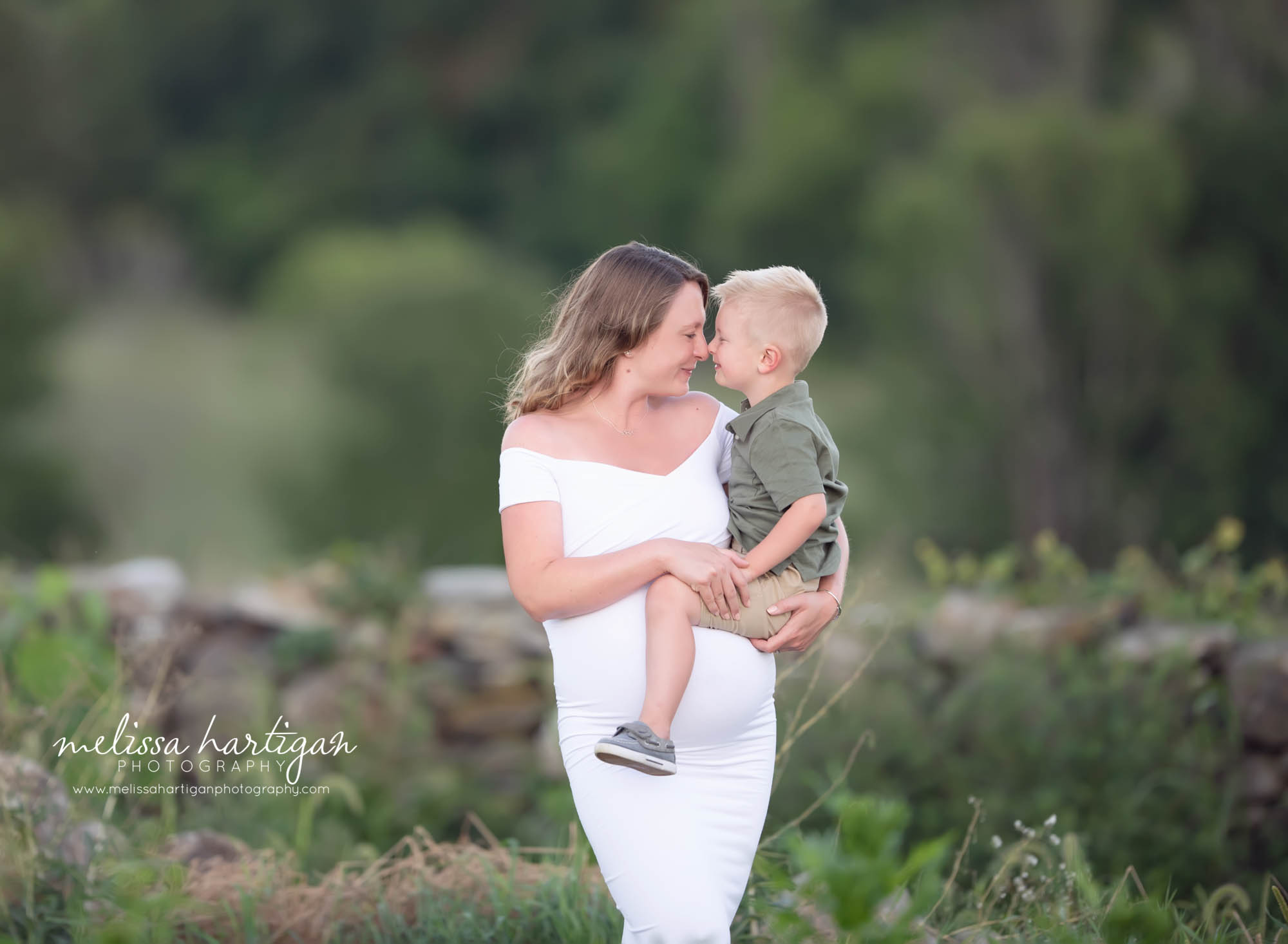 mom and toddler son touching noses face to face happy smiling love connecticut maternity photography