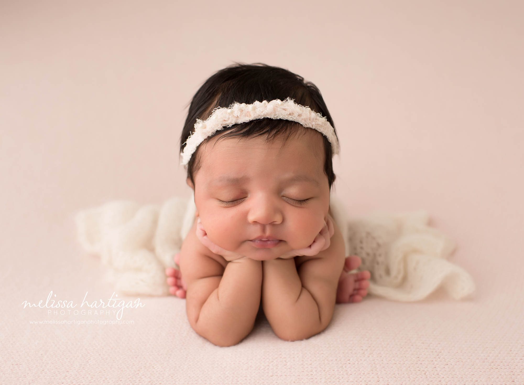 newborn baby girl posed froggy pose newborn photography session in studio