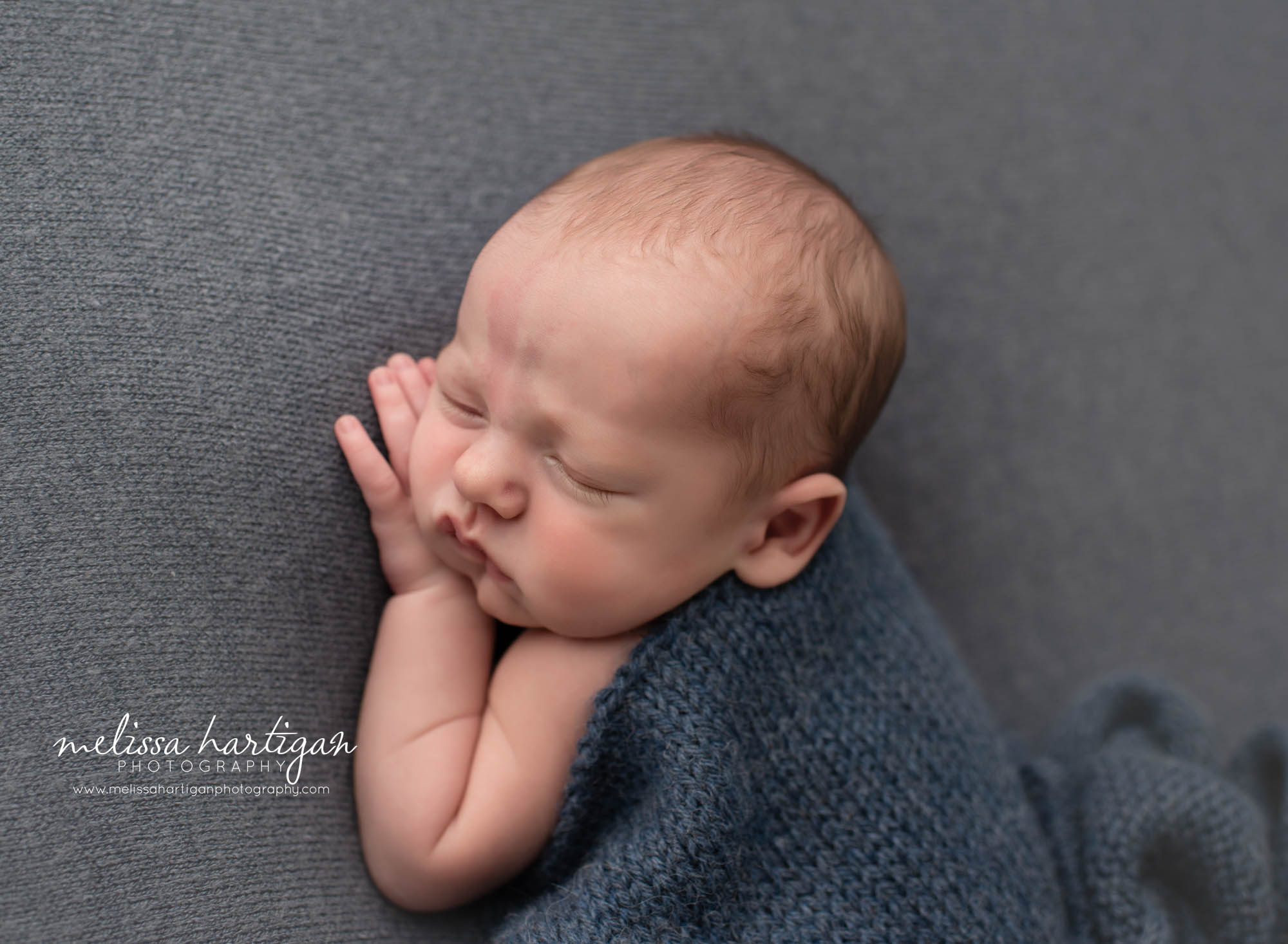 newborn baby boy posed on side with hand under cheek newborn Photography Mansfield