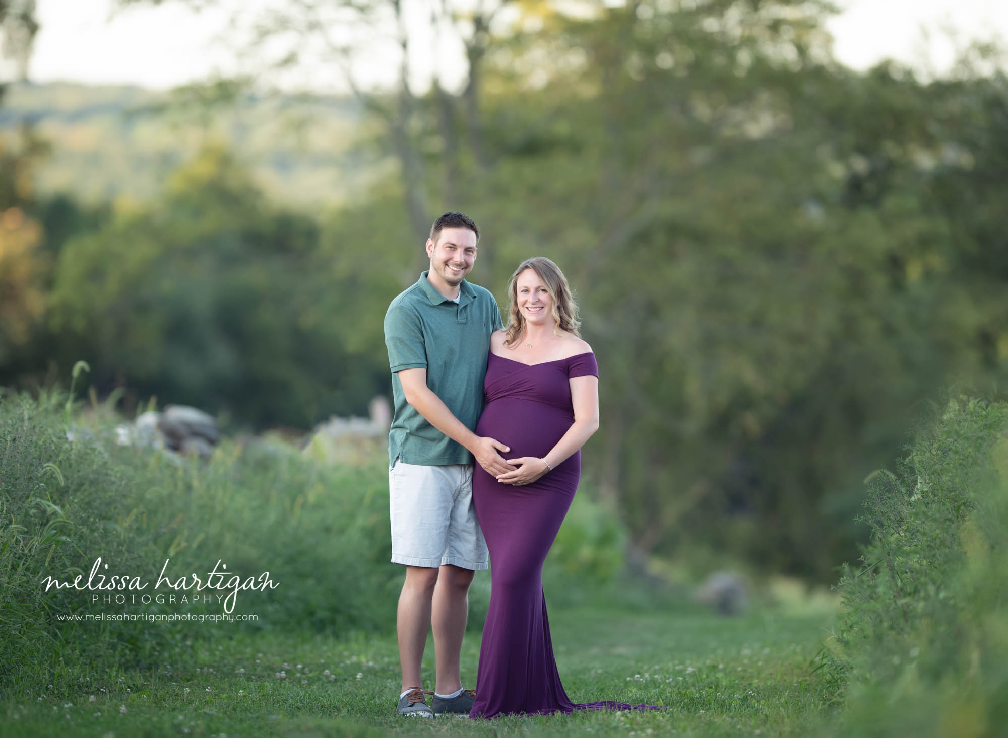 pregnant mom and dad to be holding baby bump smiling happy couple south windsor maternity photography