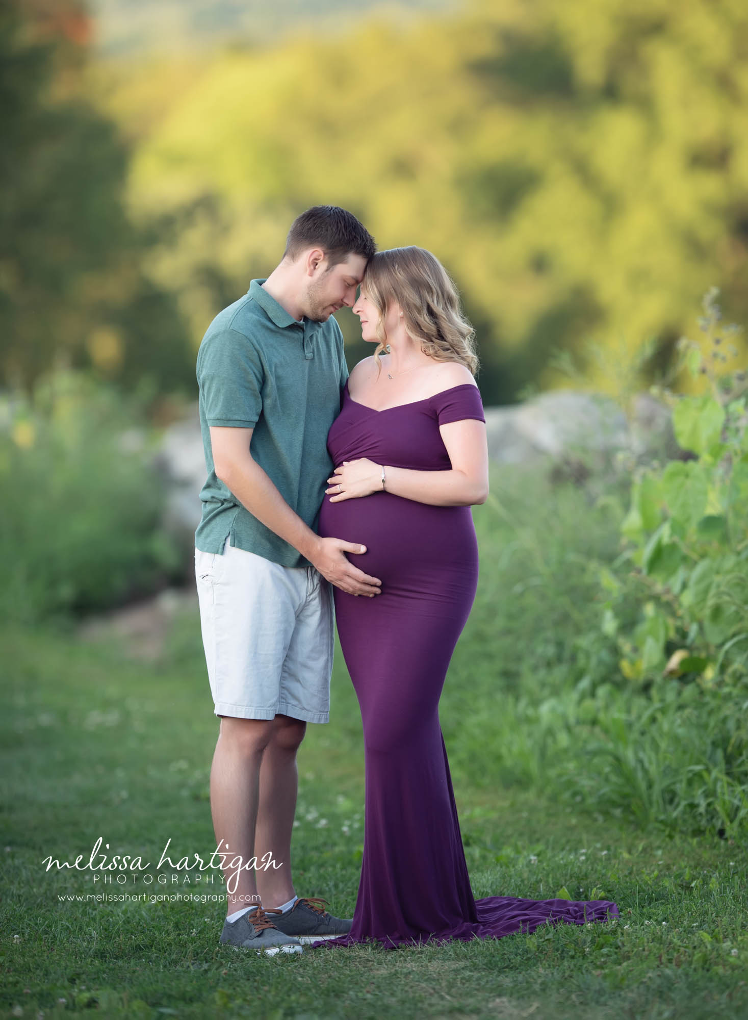 mom and dad touching foreheads holding baby bump pregnancy maternity couples photo