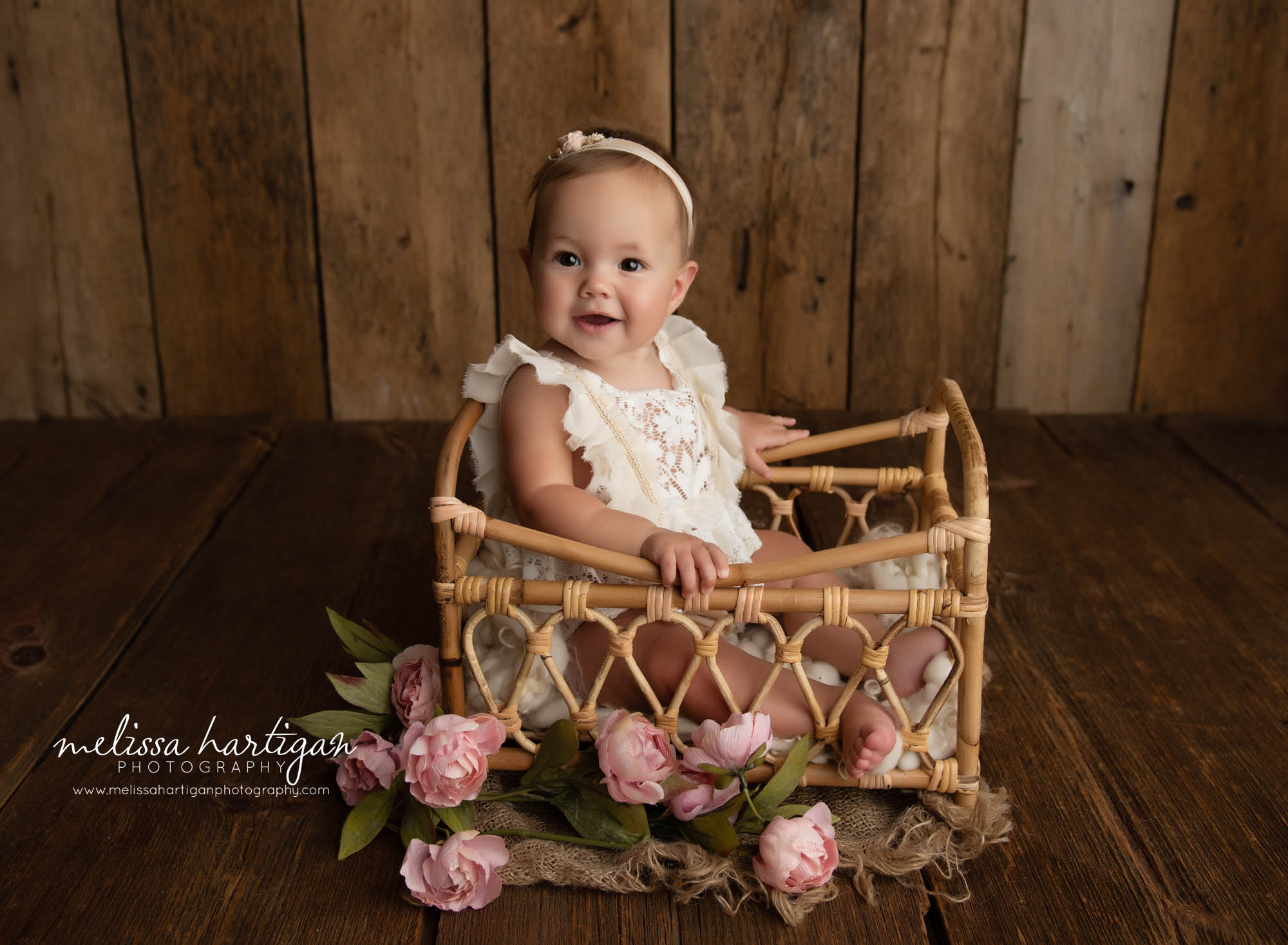 baby girl sitting up in bed prop with flowers