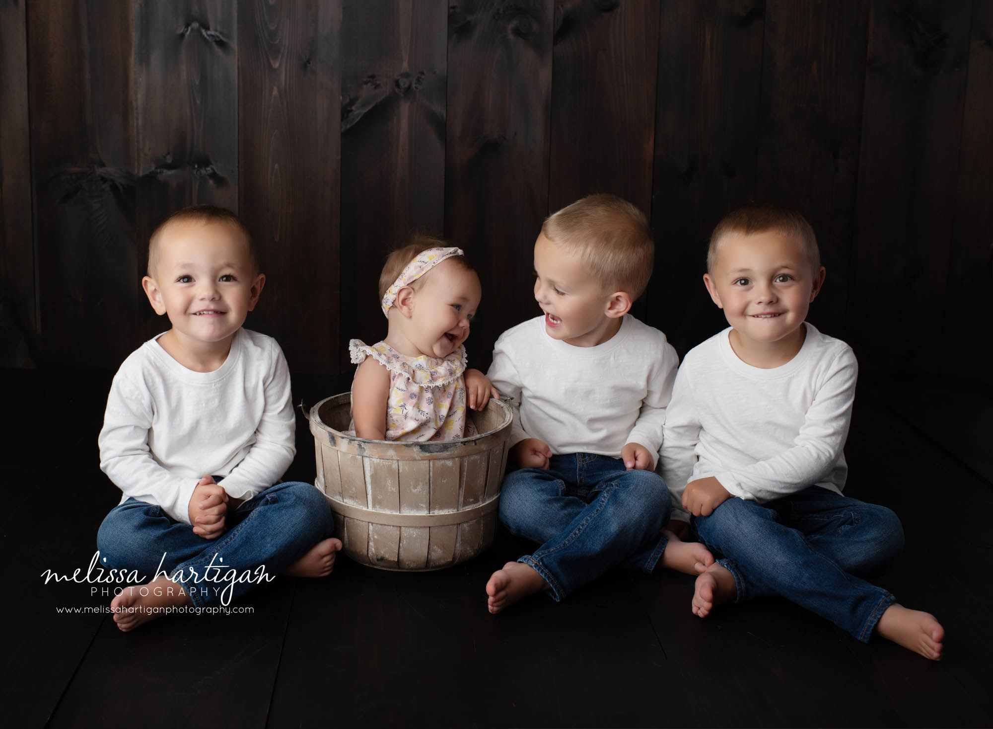baby girl laughing with her older brothers