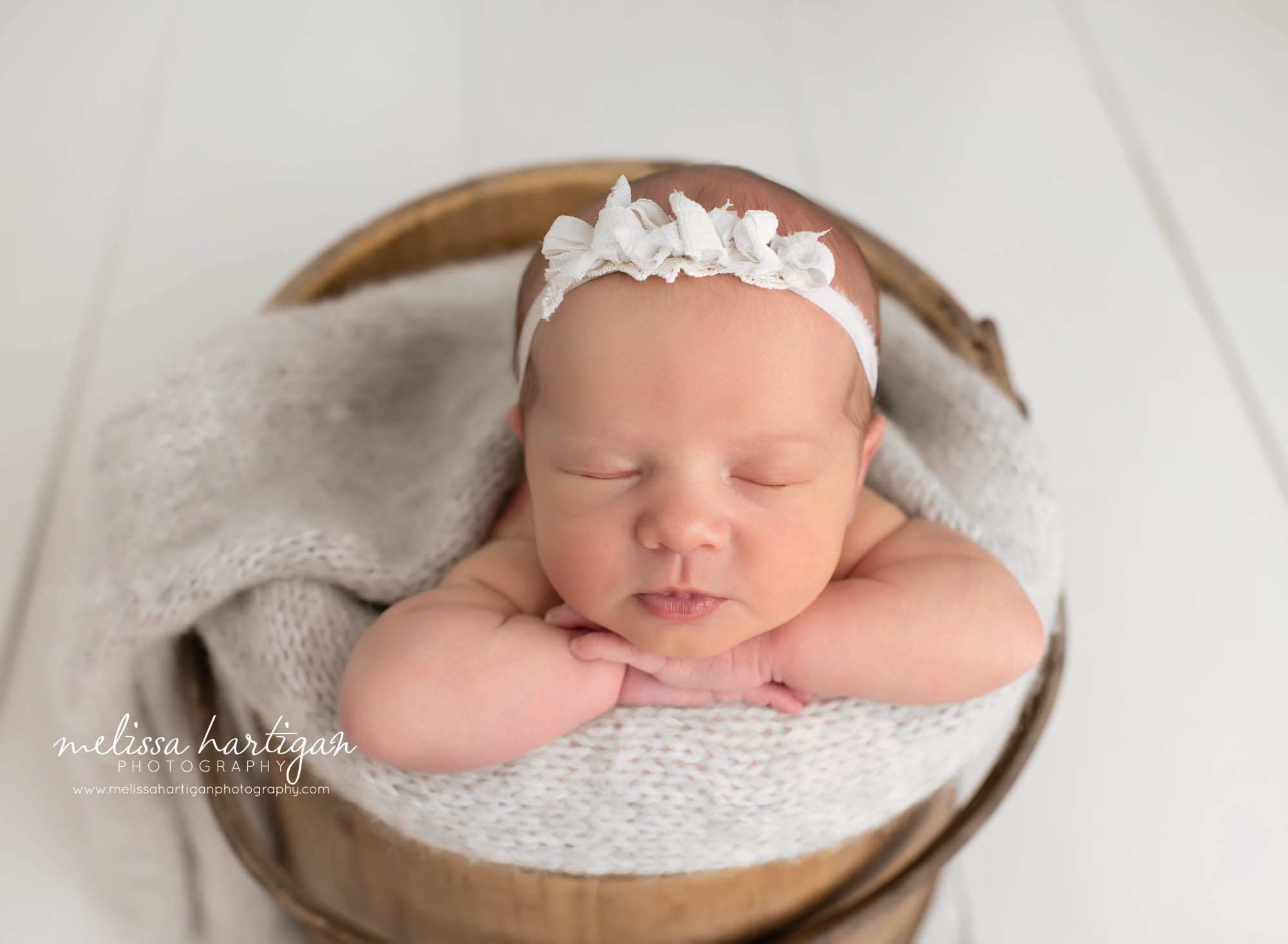 newborn baby girl posed in wooden barrel with head on hands south windsor newborn photographer