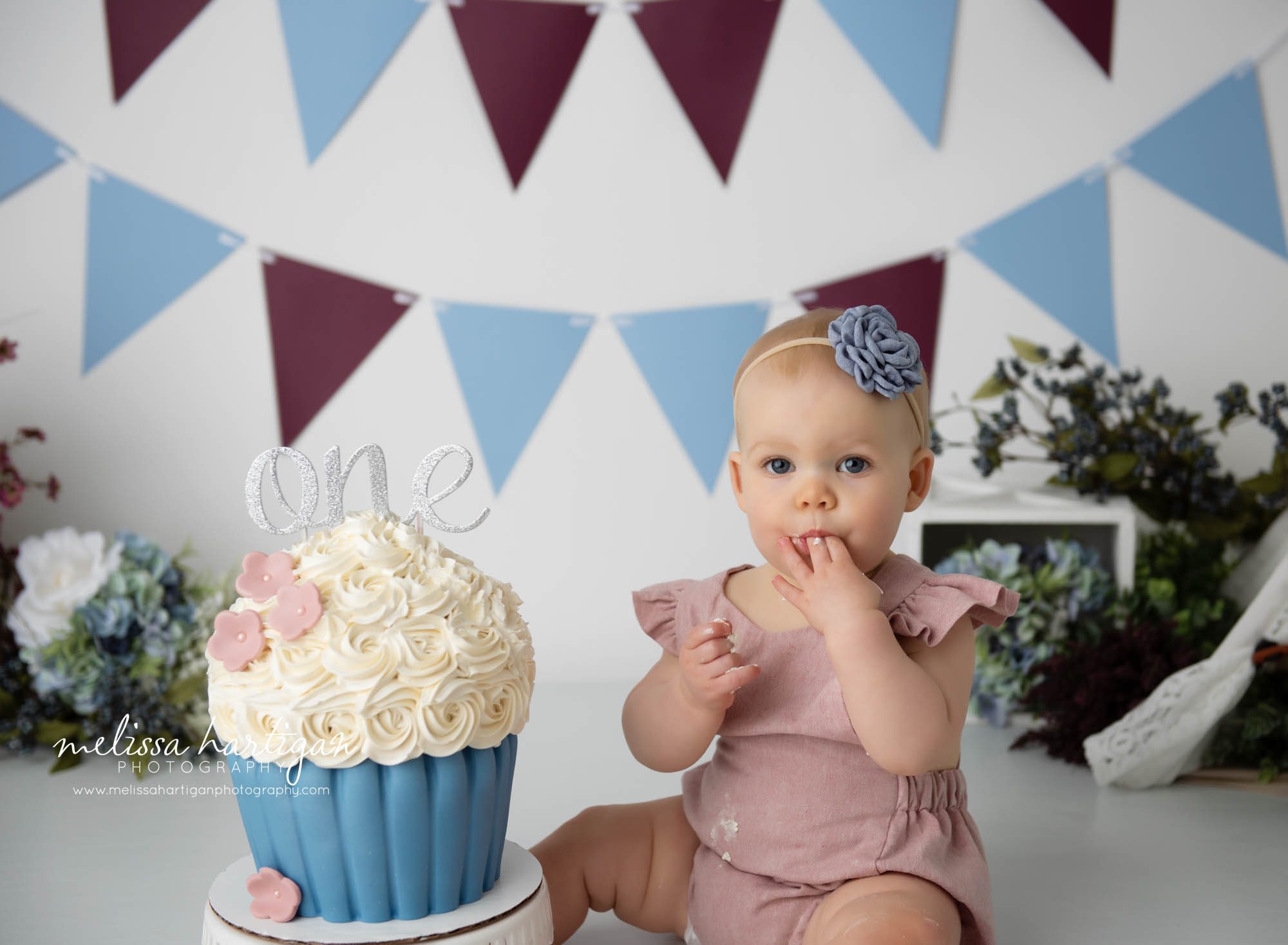baby girl tasting cake from cake smash cake ct baby milestone photographer