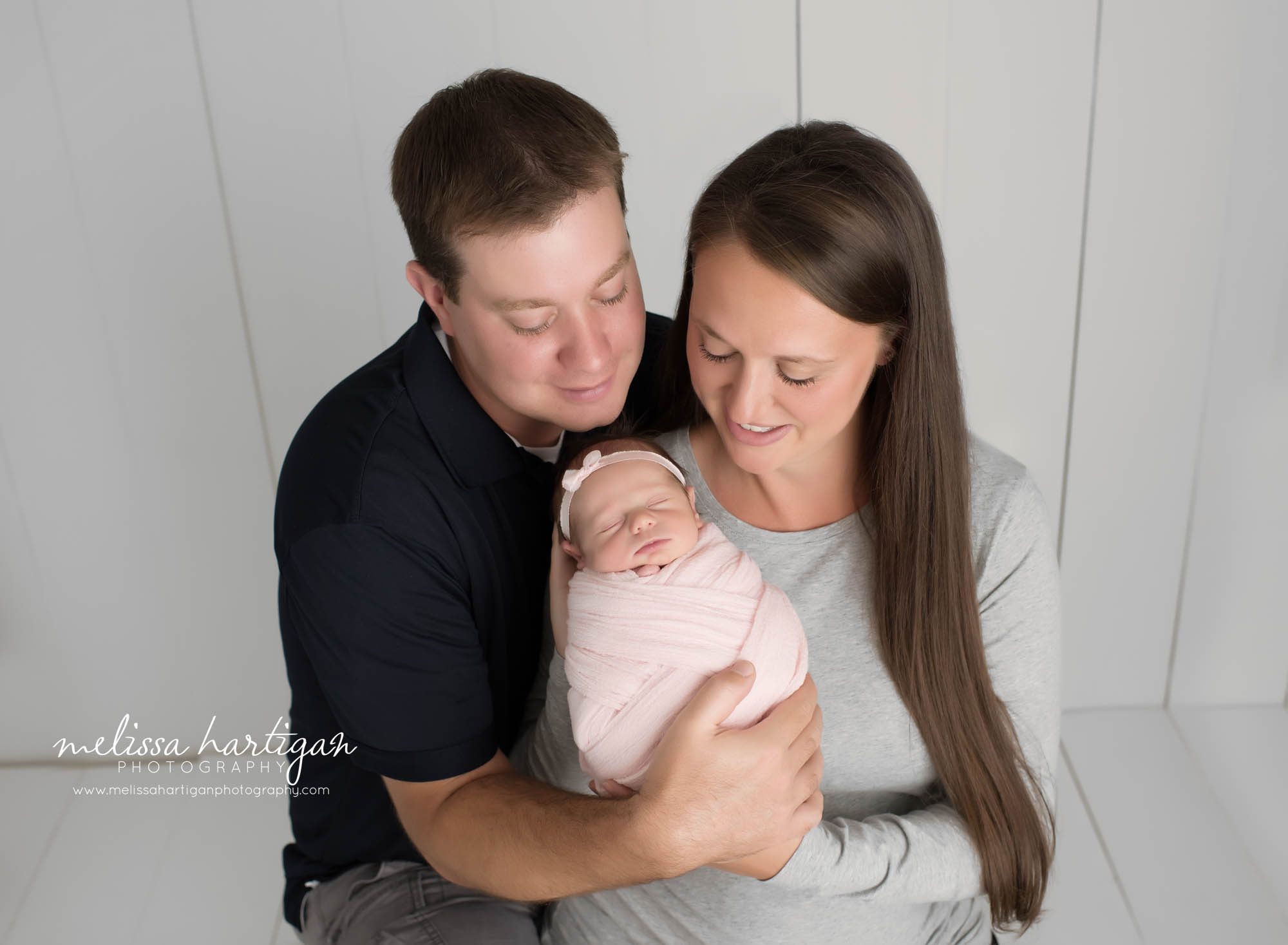mom dad and baby girl wrapped in pink wrap family photo CT baby Photography