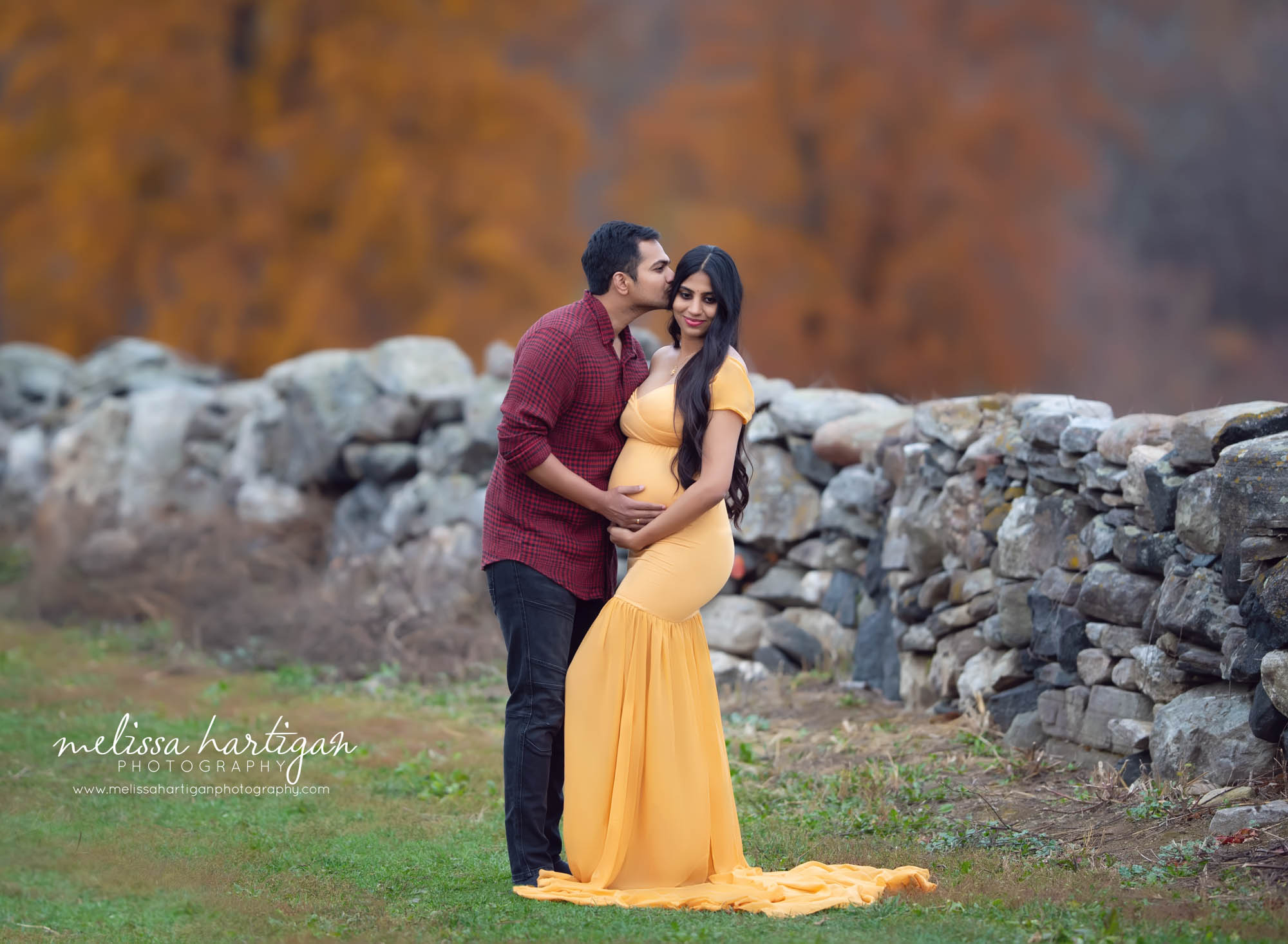 couple standing maternity picture dad kissing mom on side of head outdoors long form fitting maternity gown maternity Photography CT