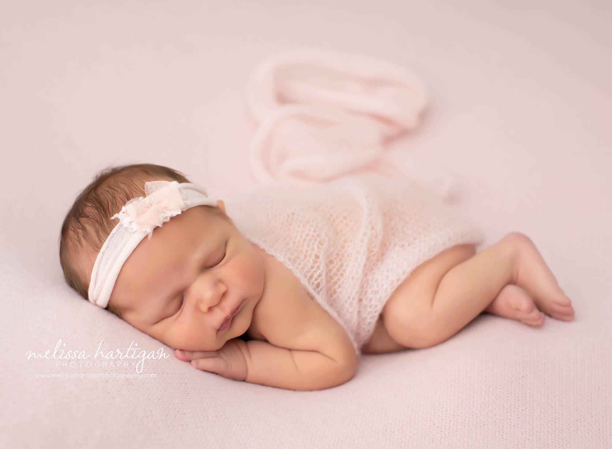 newborn baby girl posed on side with light pink knitted wrap hartford county newborn photography
