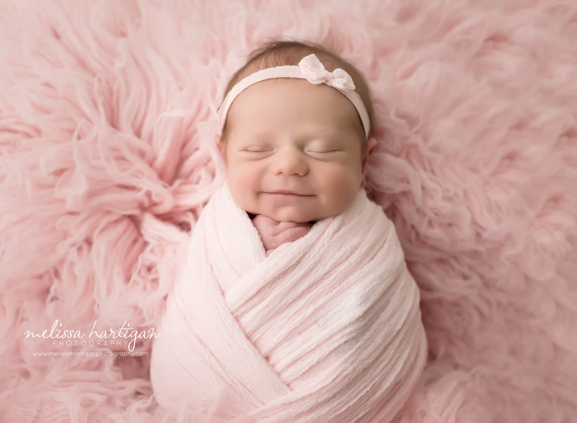 newborn baby girl smiling in picture Massachusetts newborn photographer