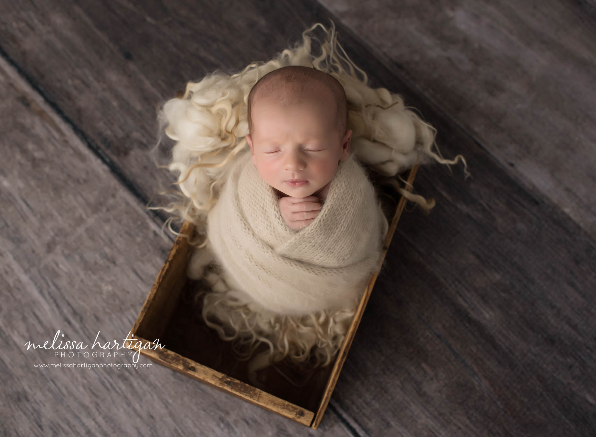 newborn baby boy wrapped in knitted wrap with neutral earth tone colors tolland county newborn photography