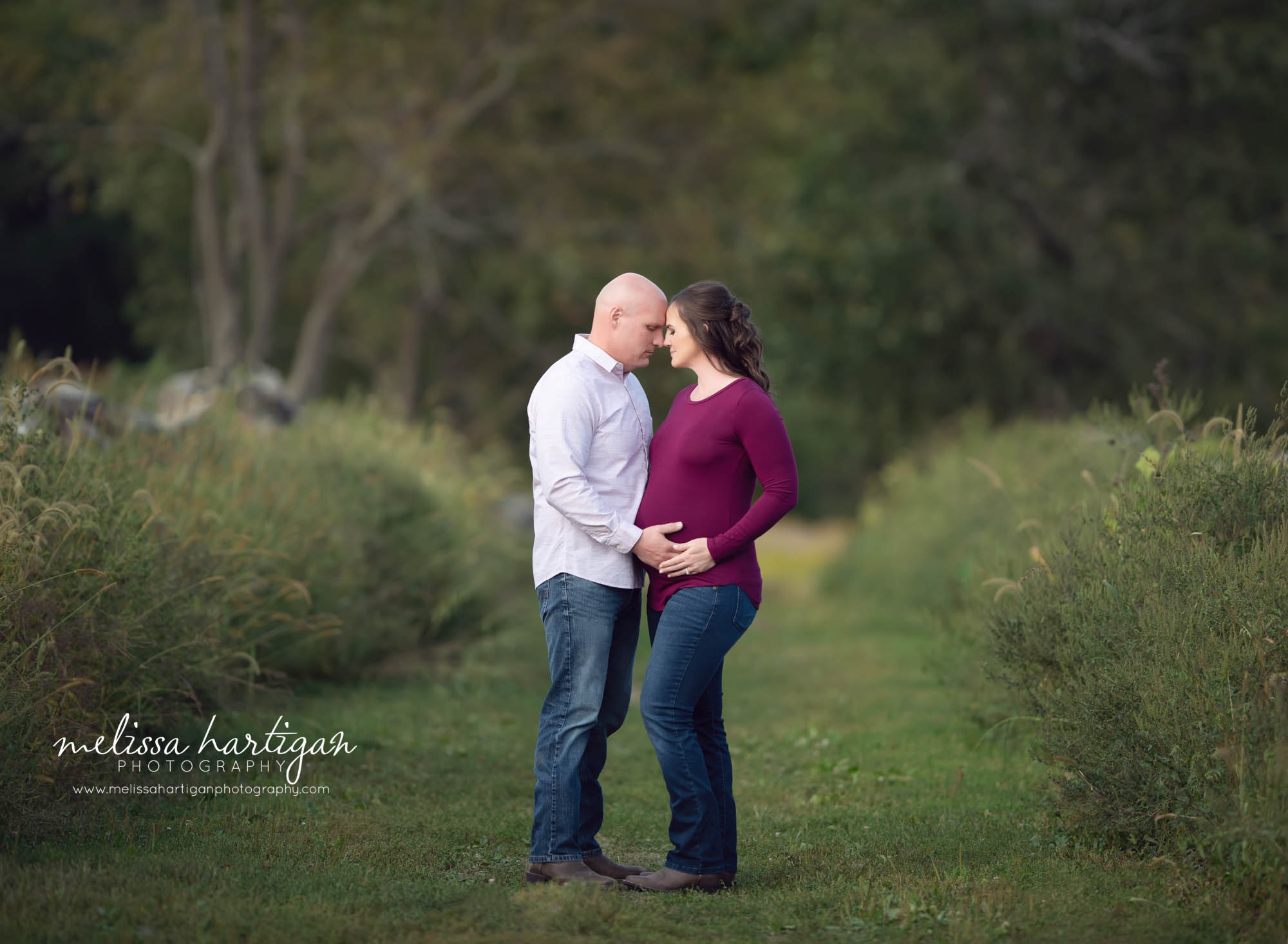 mom dad foreheads touching holding baby bump pregnancy pictures CT