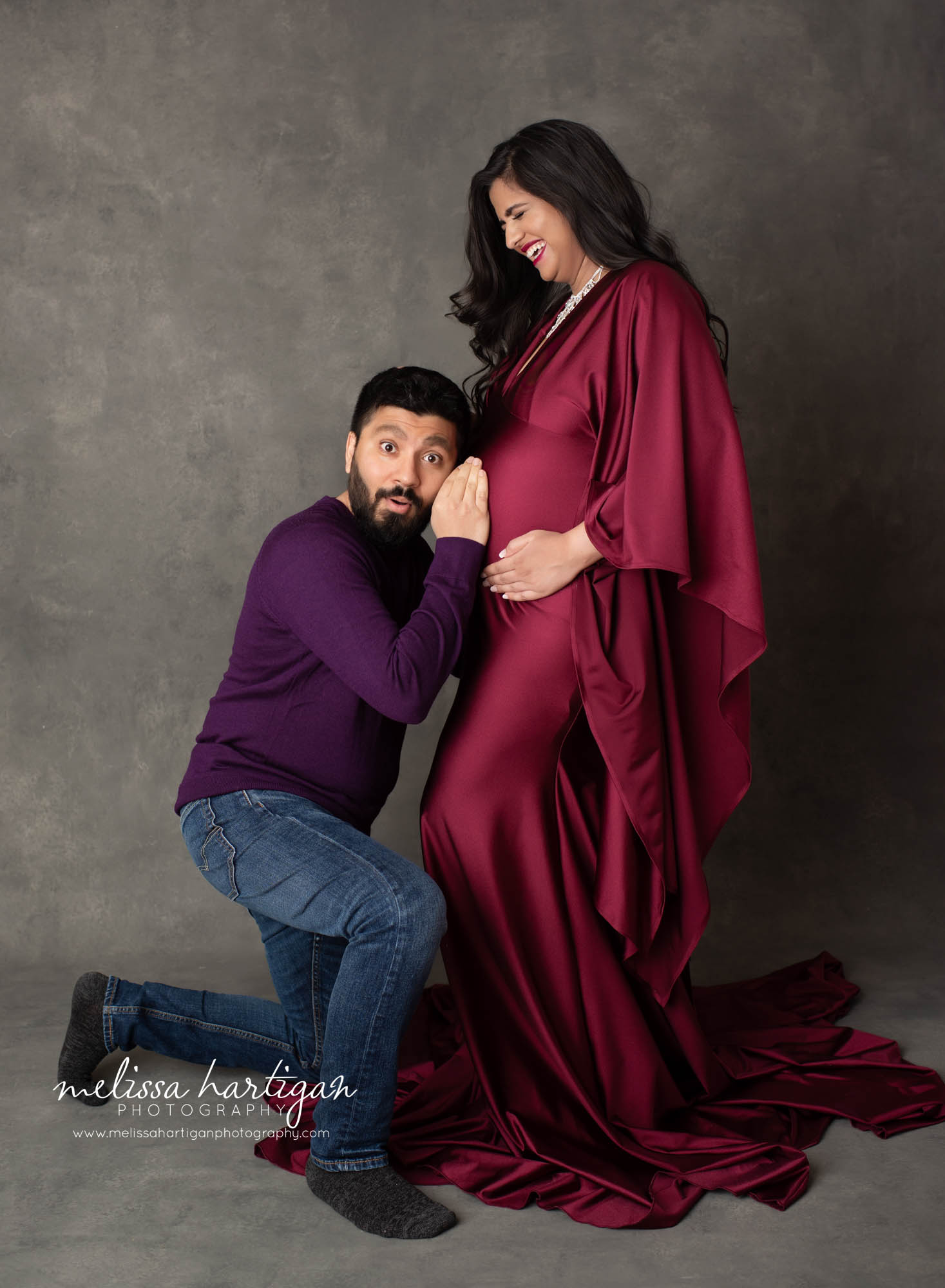 dad kneeling down with ear to baby bump silly maternity CT maternity photographer