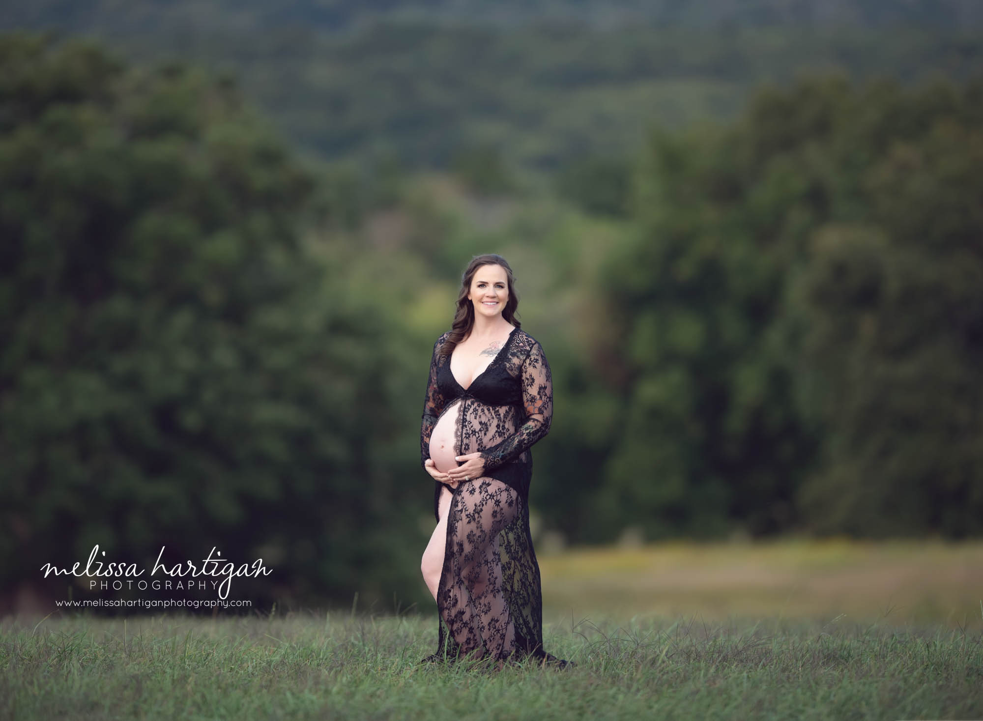 pregnant mom wearing lace dress open front smiling at camera Connecticut maternity photography